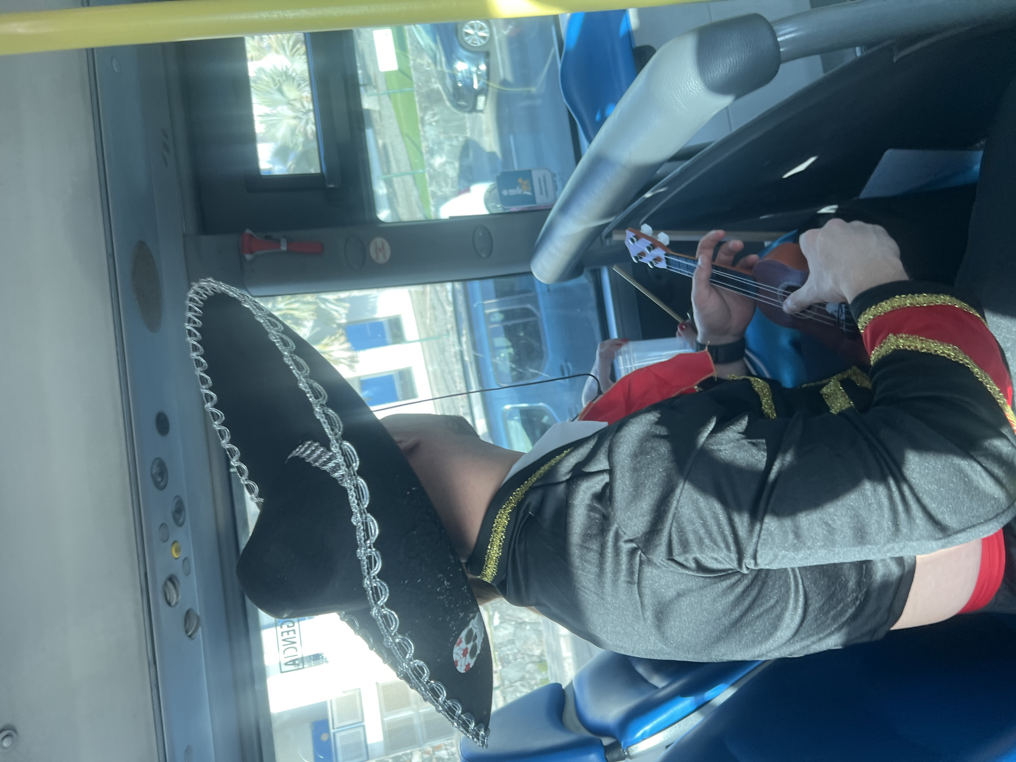 Mariachi musician plays ukulele on public bus in Spain