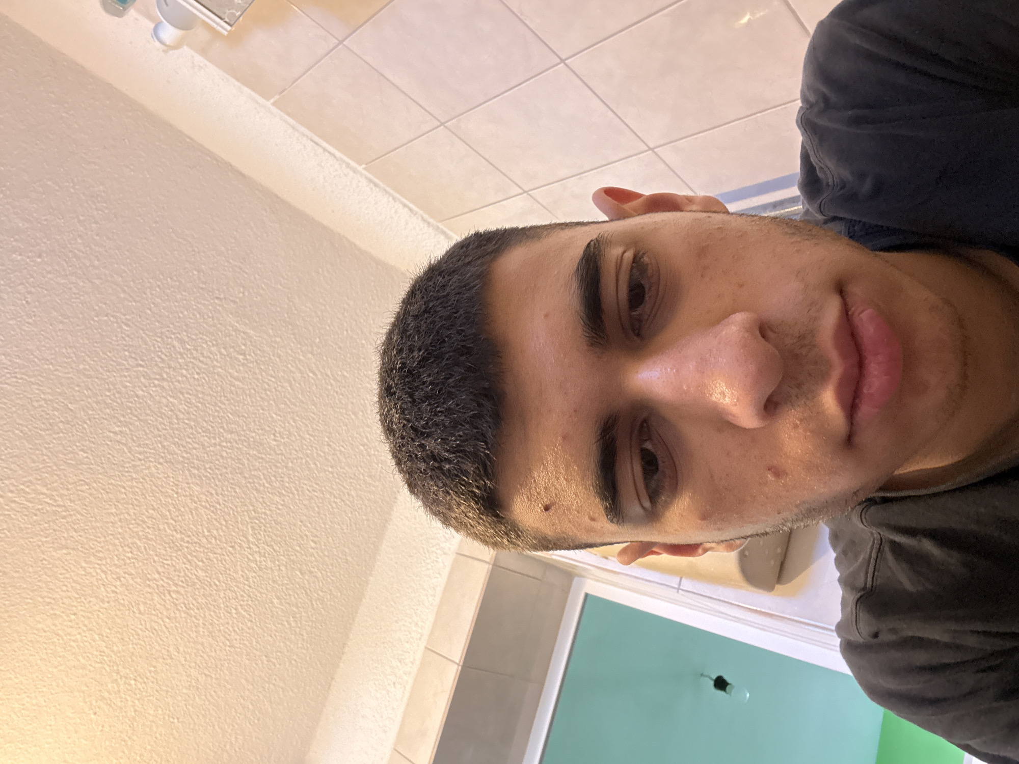 Young man takes bathroom selfie in Sofia, Bulgaria