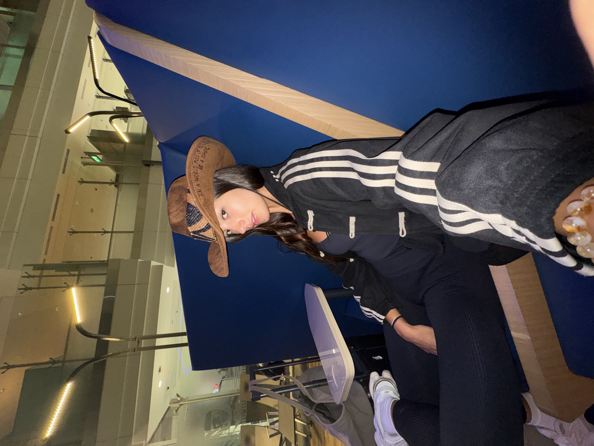 Cowboy hat and Adidas jacket in a Dubai lounge