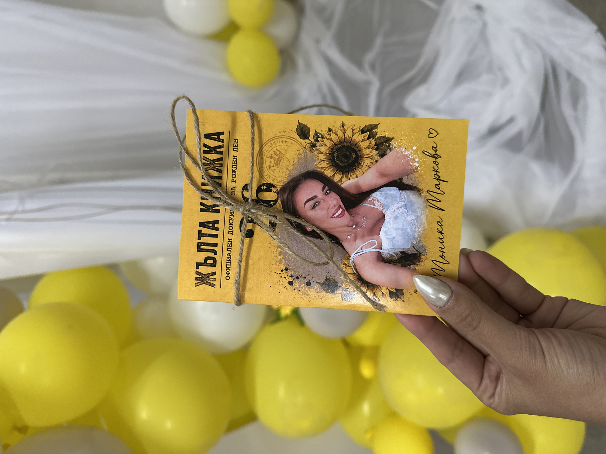 Handmade yellow booklet with sunflower at a balloon-filled gathering