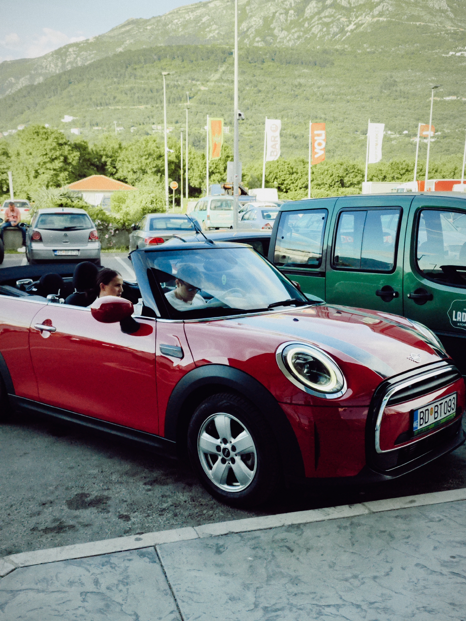 Red Mini Cooper, cyclists gather in Dub parking lot