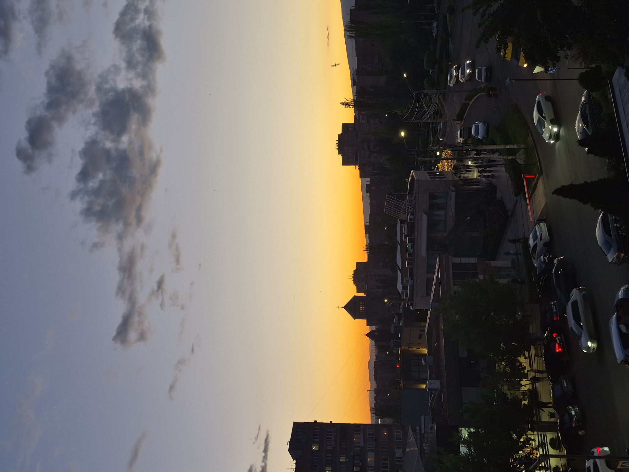 Sunset documented over Yerevan Armenia cityscape with church silhouette