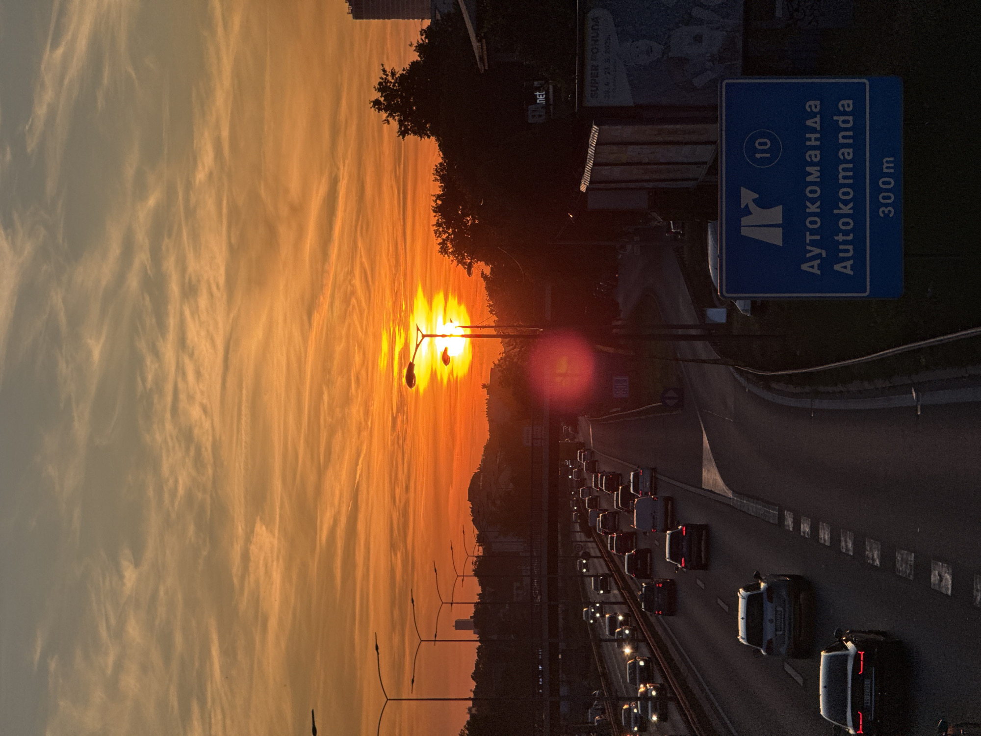 Golden sunset illuminates busy Belgrade highway during evening rush