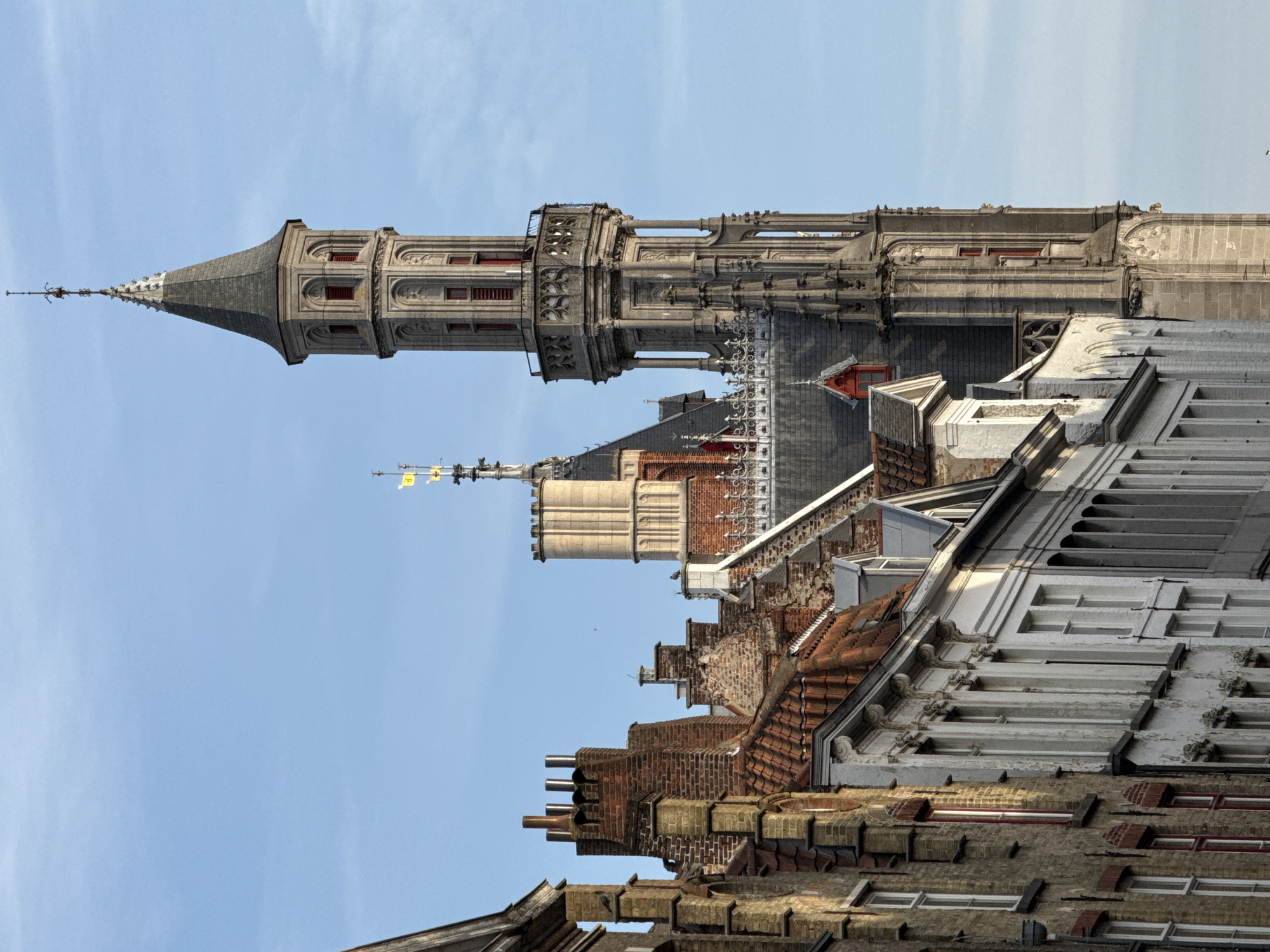 Looking up at Bruges' historic rooflines and wooden facades