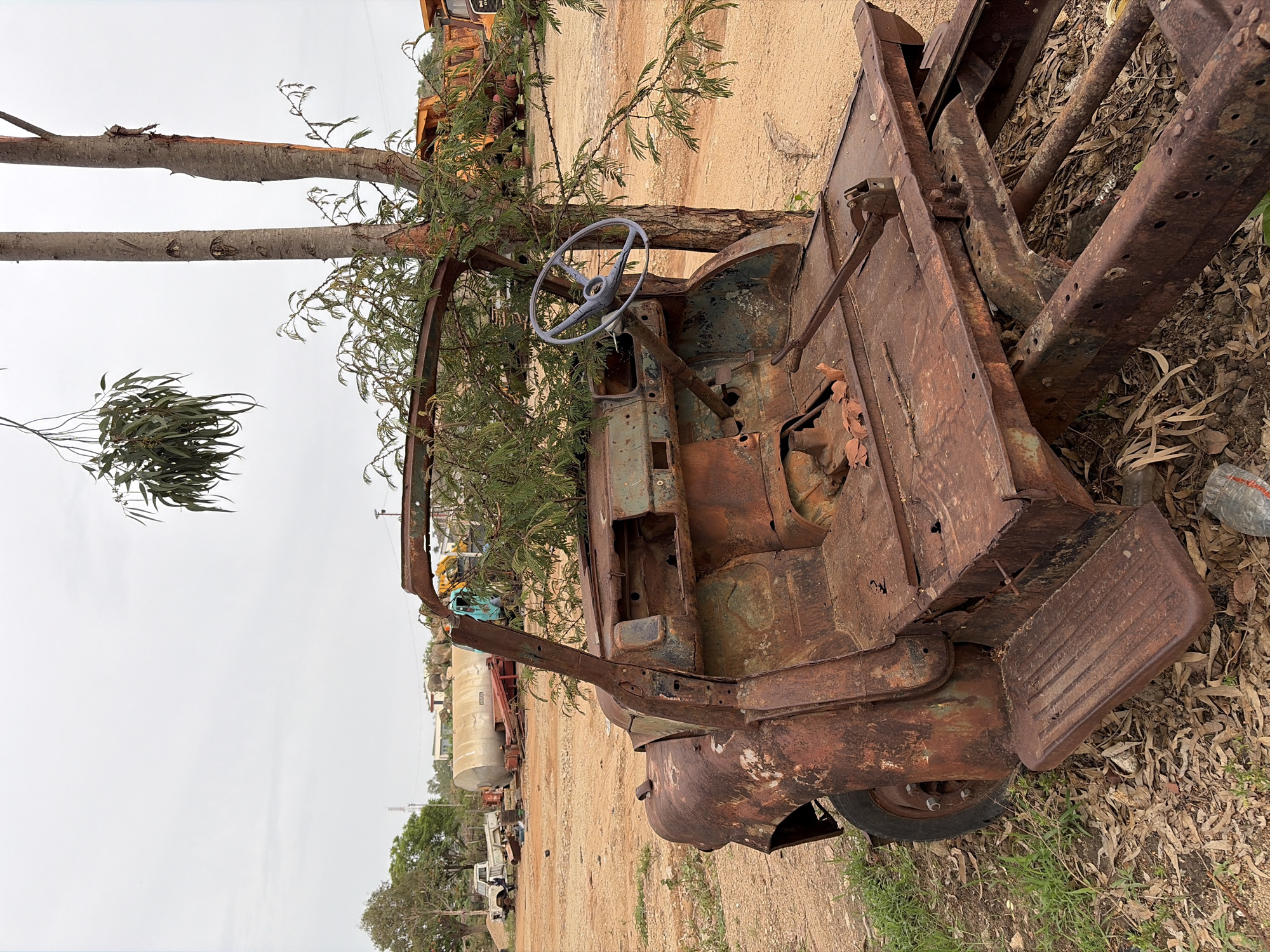 Scrap metal collection operation at Nigerian vehicle graveyard