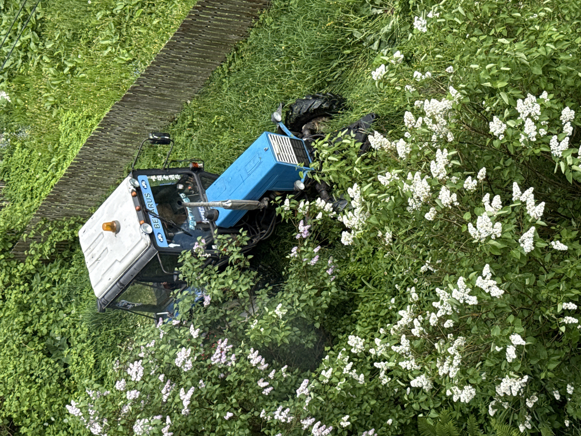 Woman photographs herself near tractor in rural Russia