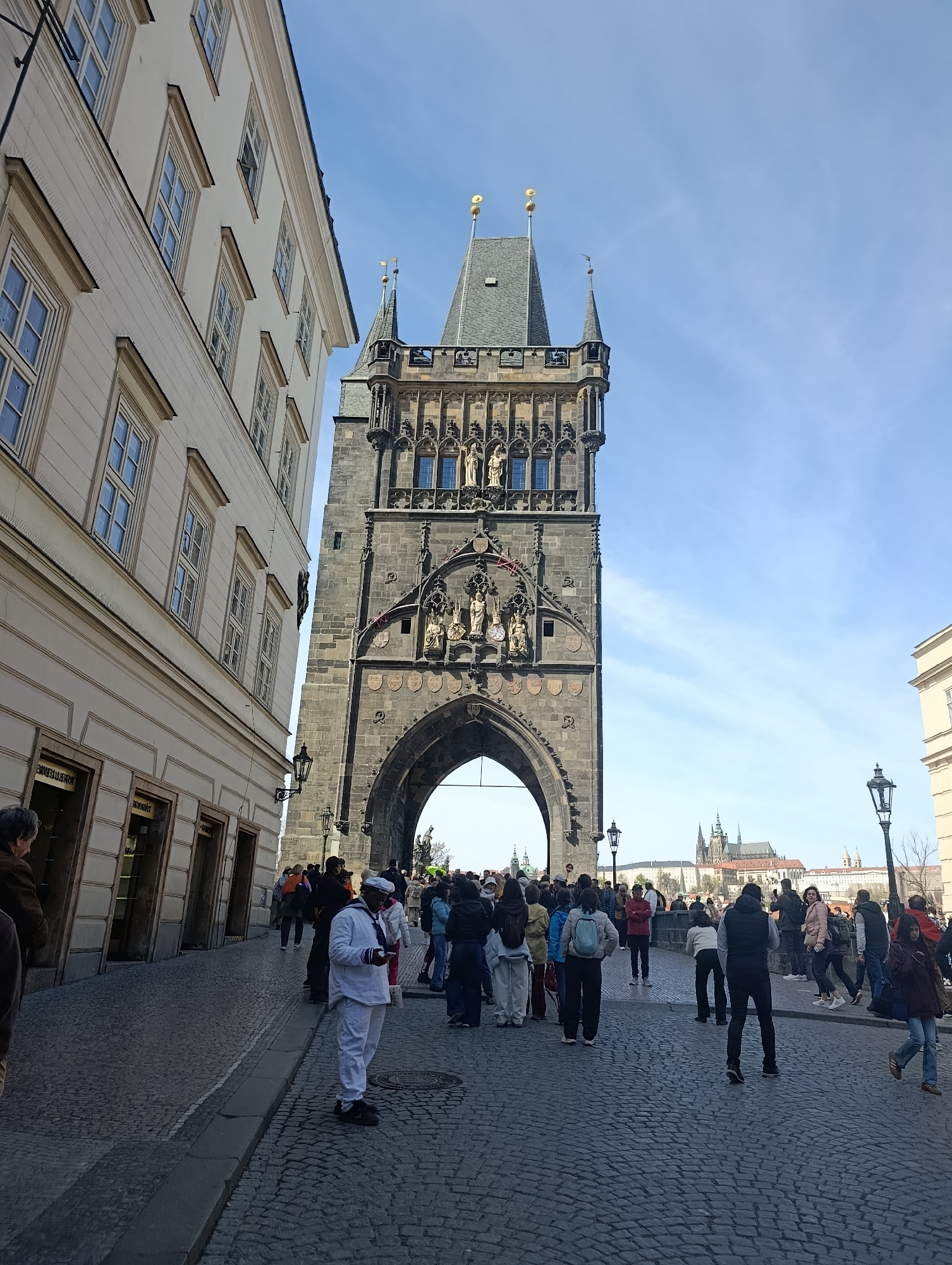 Historic Powder Tower documented in Prague with pedestrian activity