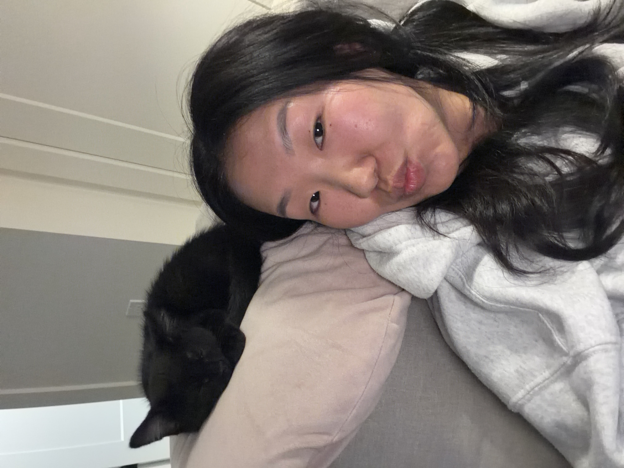 Woman spends quiet moments with black cat in New Westminster home