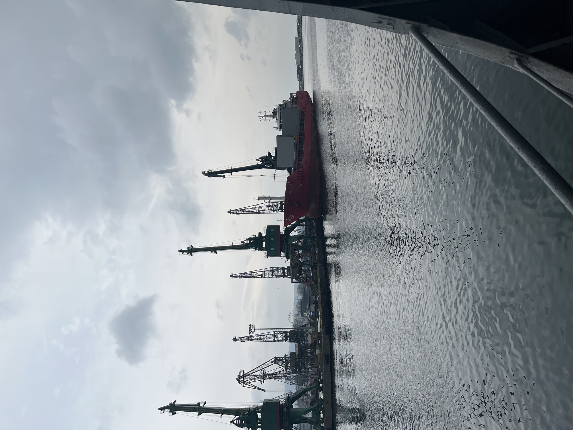 Cargo ship docked at Varna port under cloudy skies