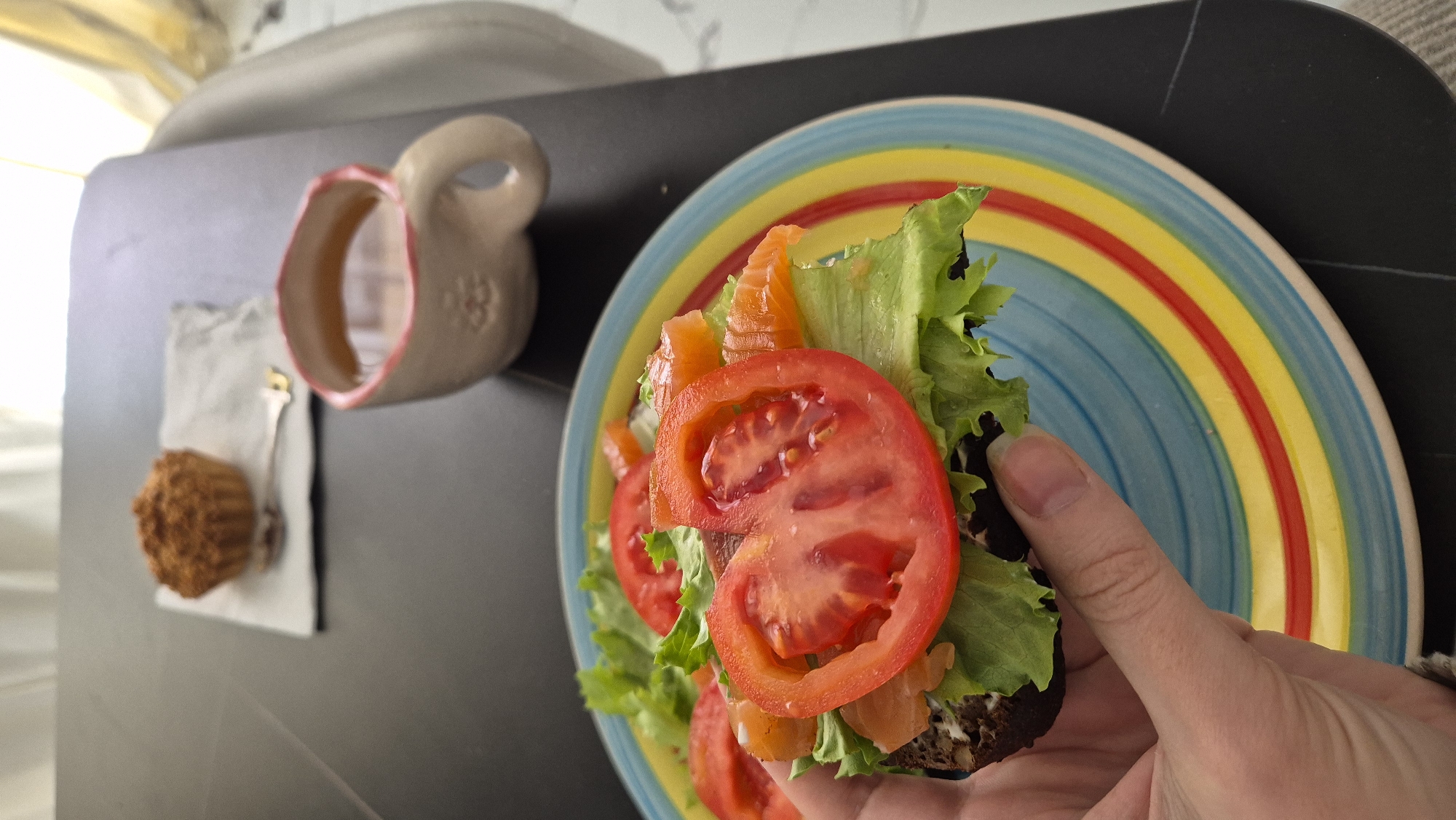 Woman enjoys salmon sandwich breakfast in Batumi restaurant