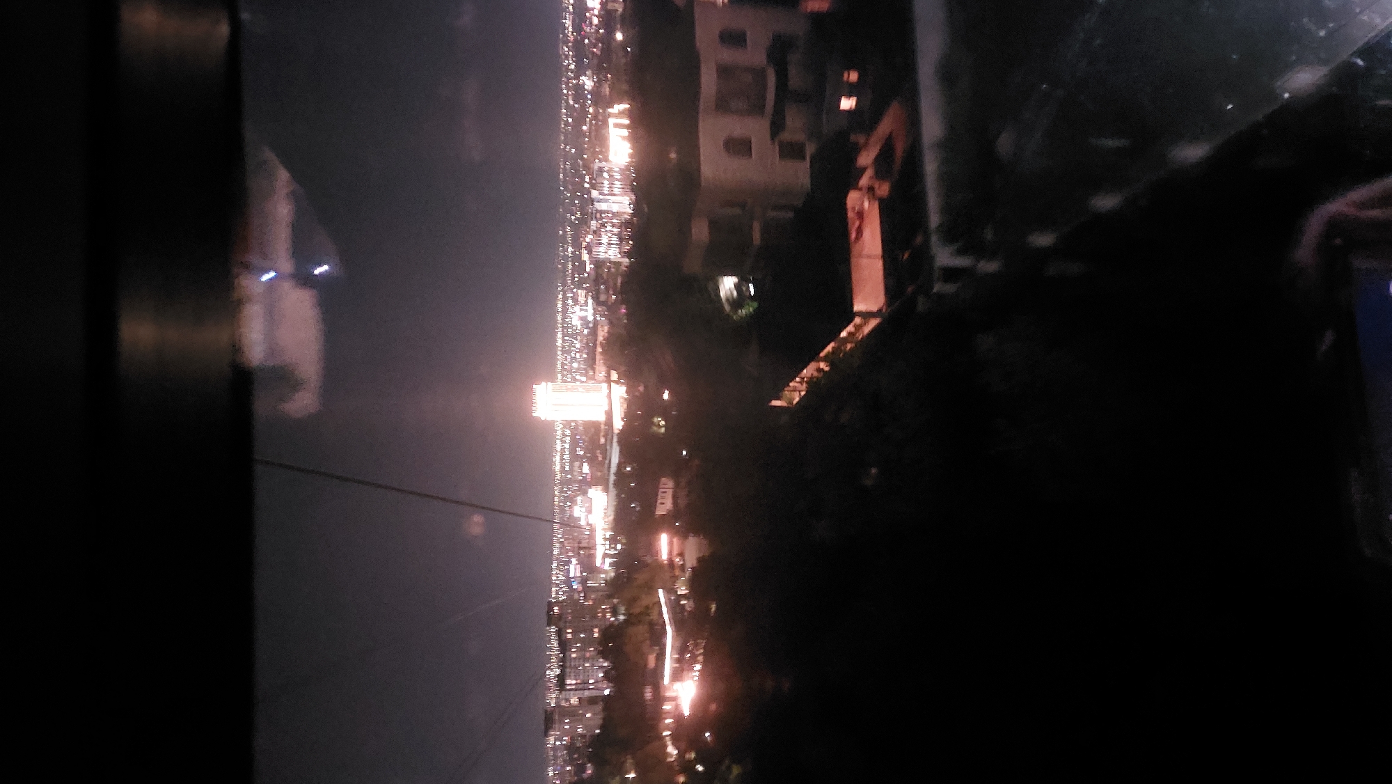 Almaty's nighttime cityscape and highway from above