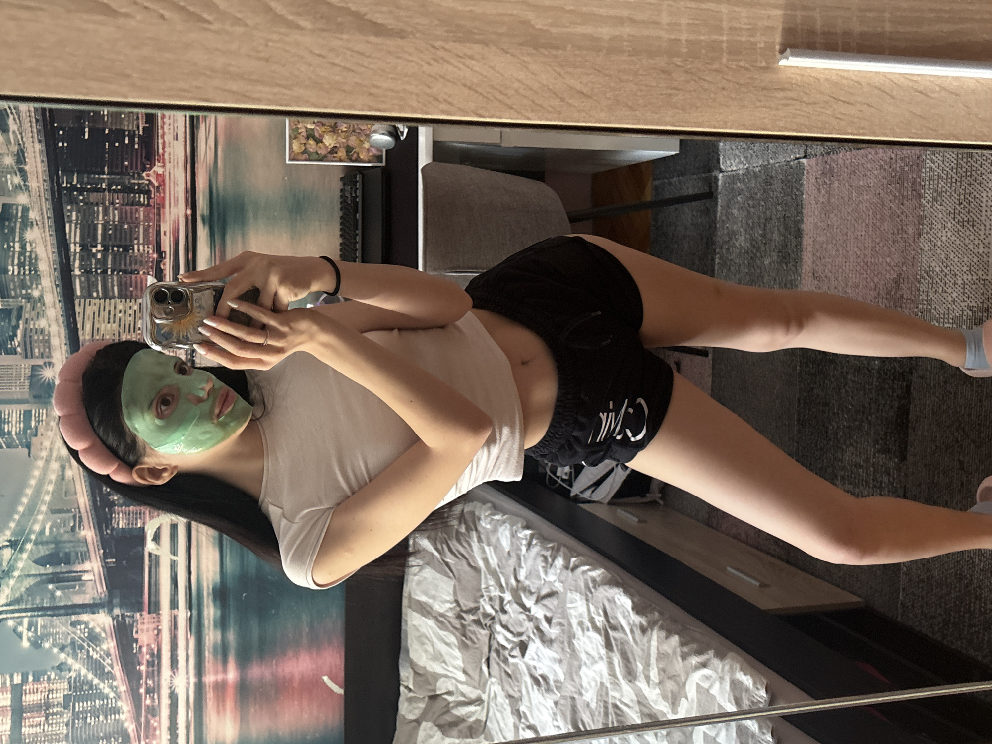 Woman takes spa day selfies in Sofia bedroom