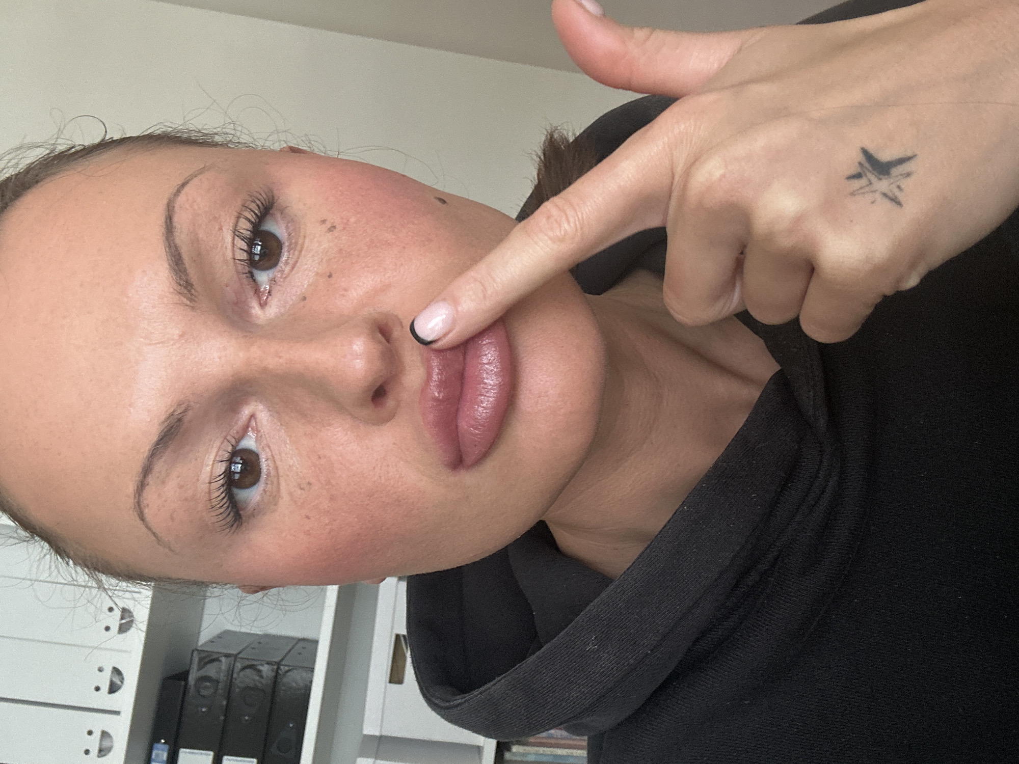 Woman makes shush gesture in Tunbridge Wells