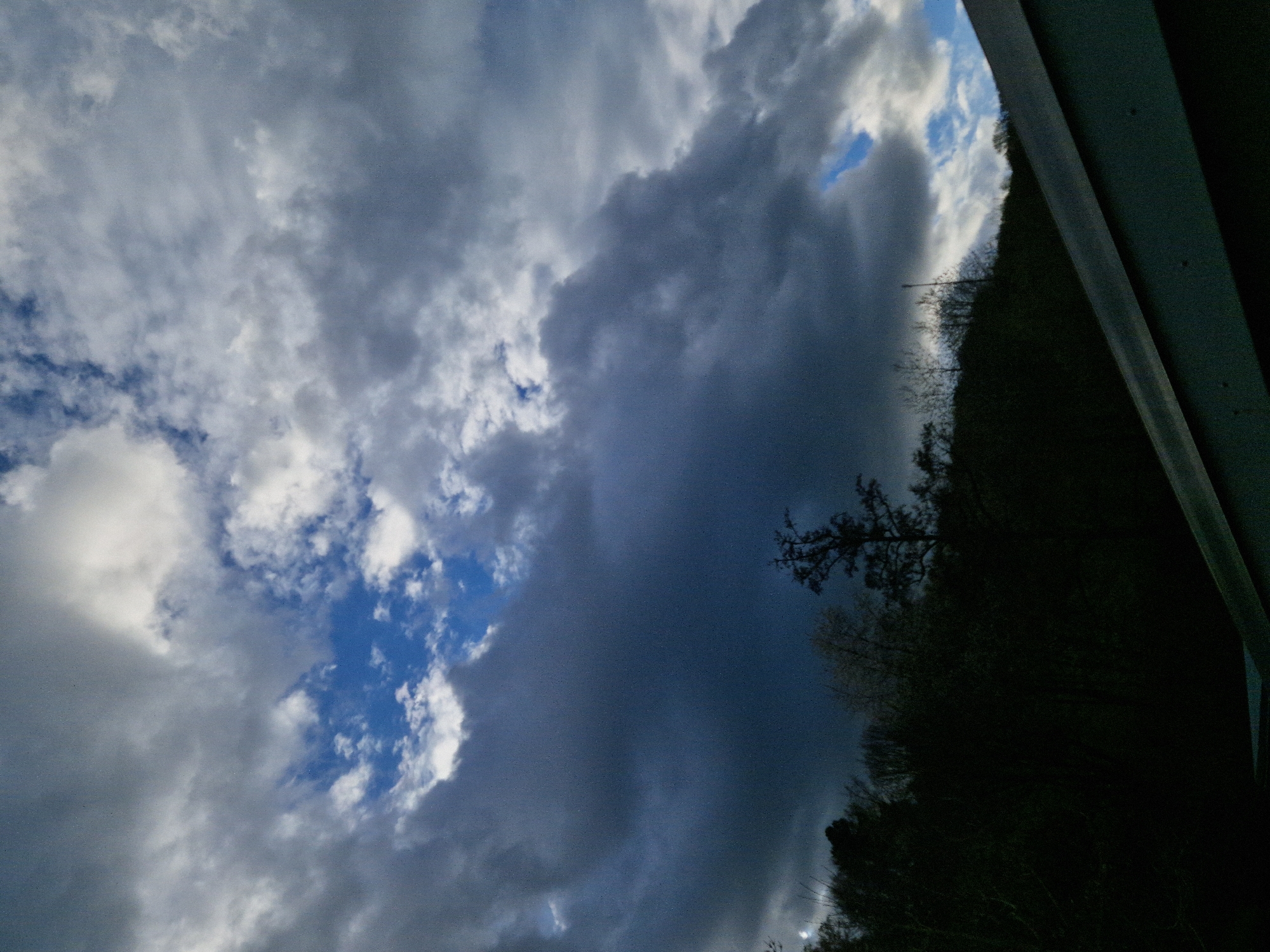 Dark clouds gather over German woodland near Leidersbach