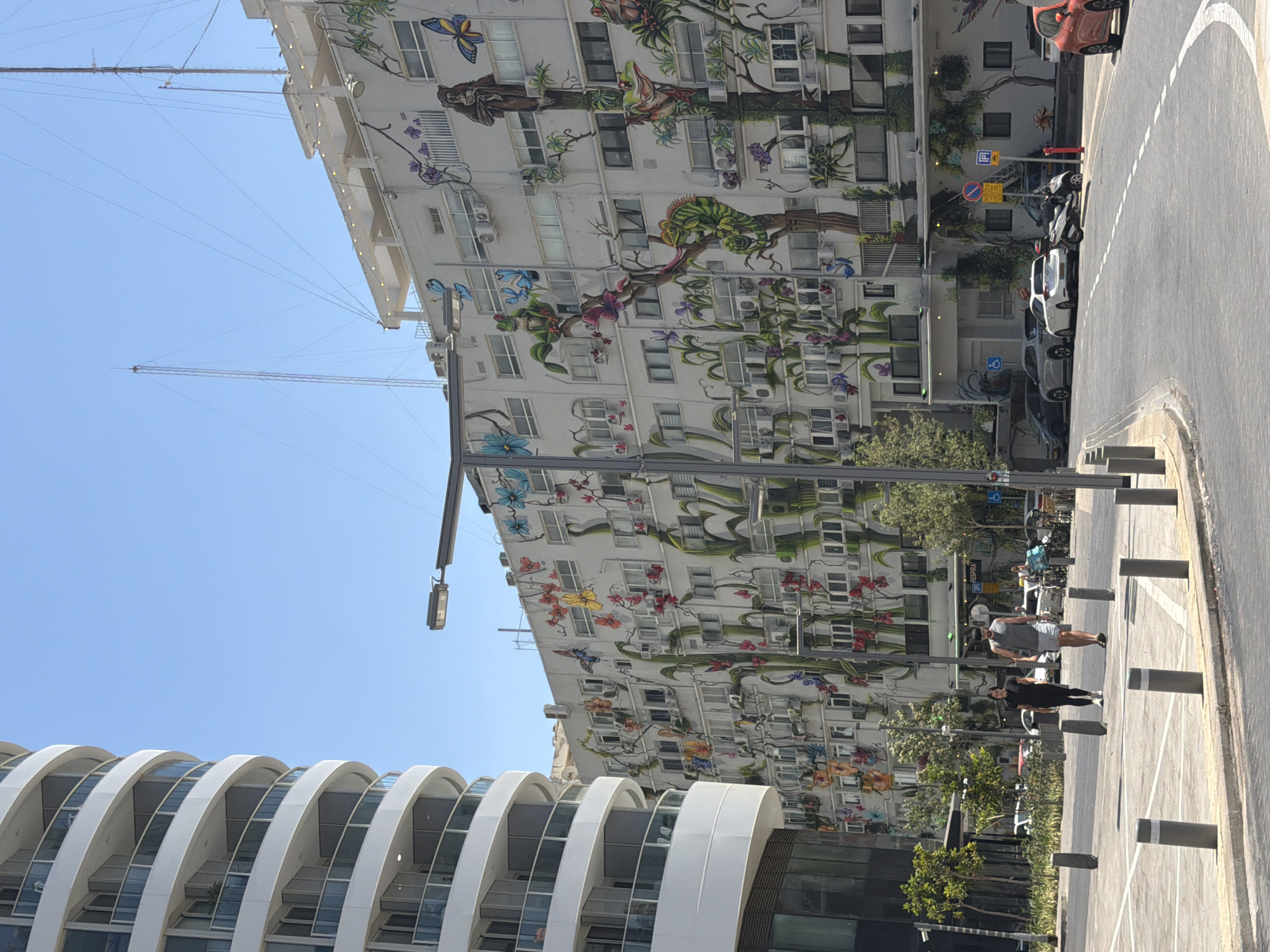 Tel Aviv street framed by modern white residential buildings