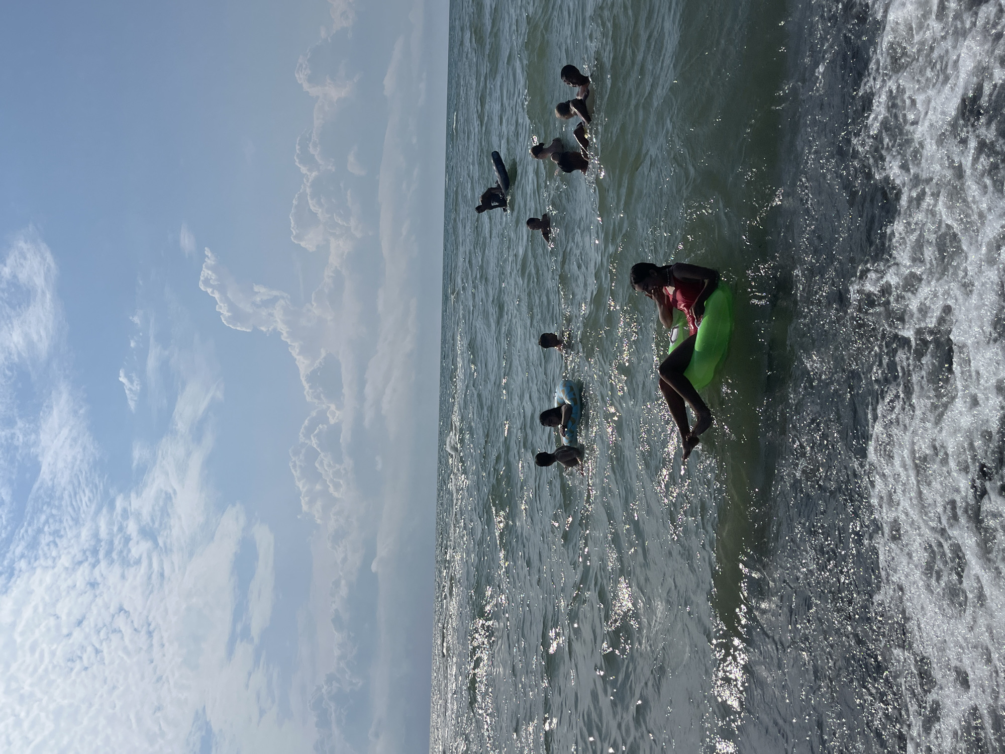 Busy summer day on Ureki's black sand beach