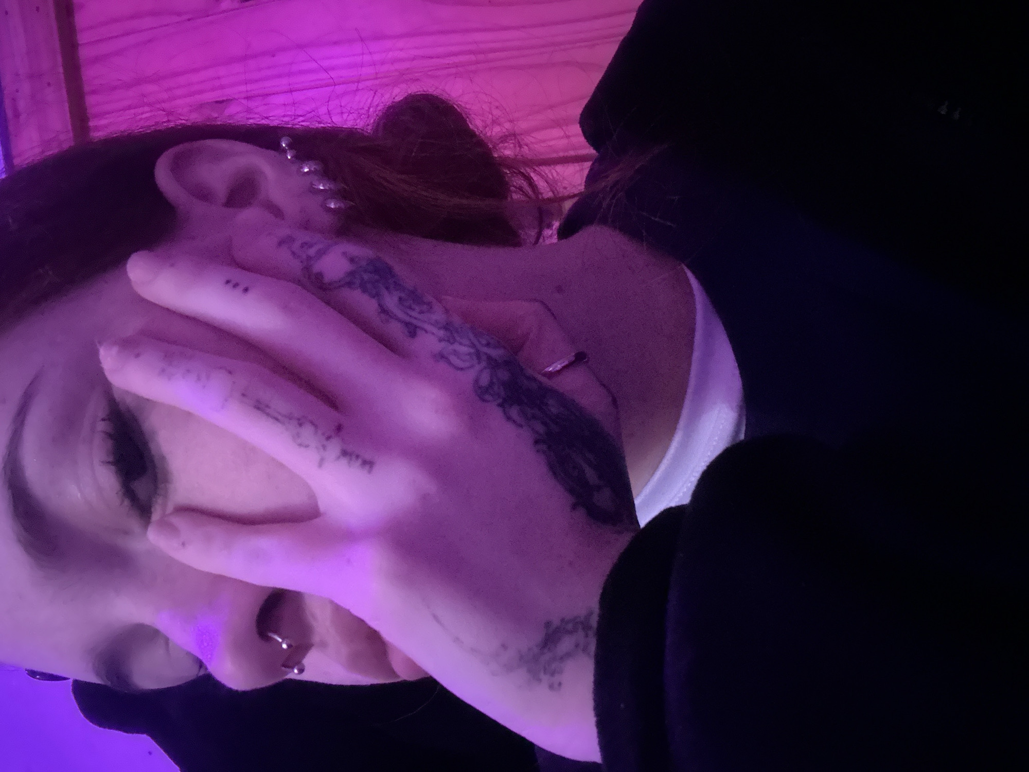 Tattooed, pierced, under purple light in Buenos Aires nightlife