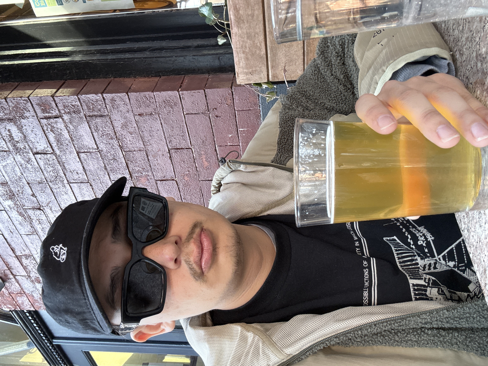 Person enjoys beer outdoors in New York City
