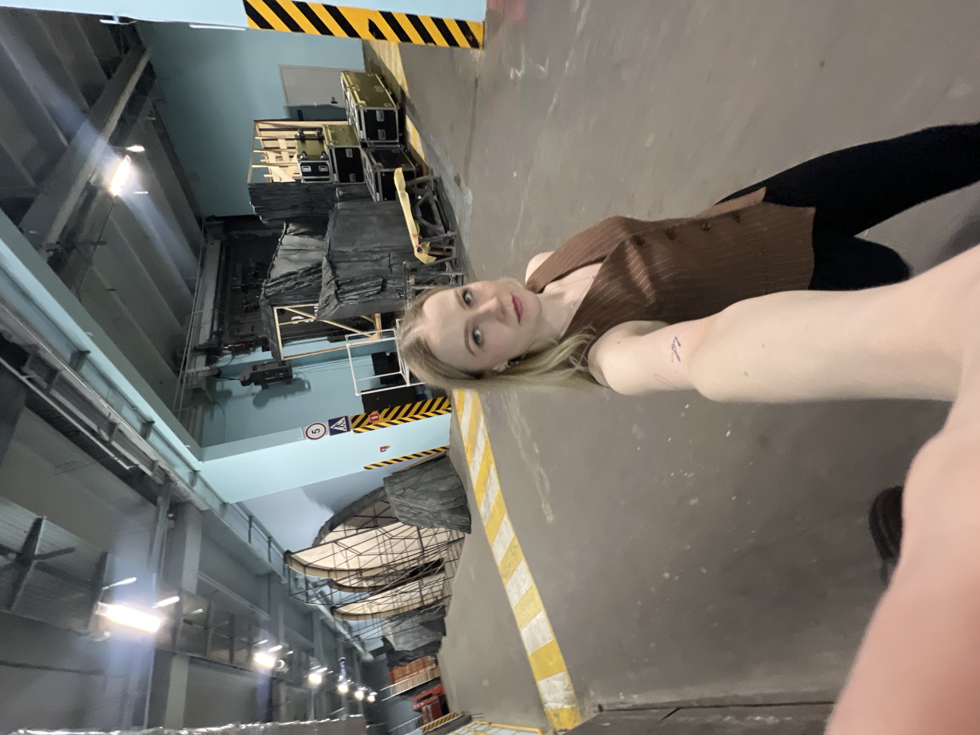Woman takes selfie in industrial space in Khimki