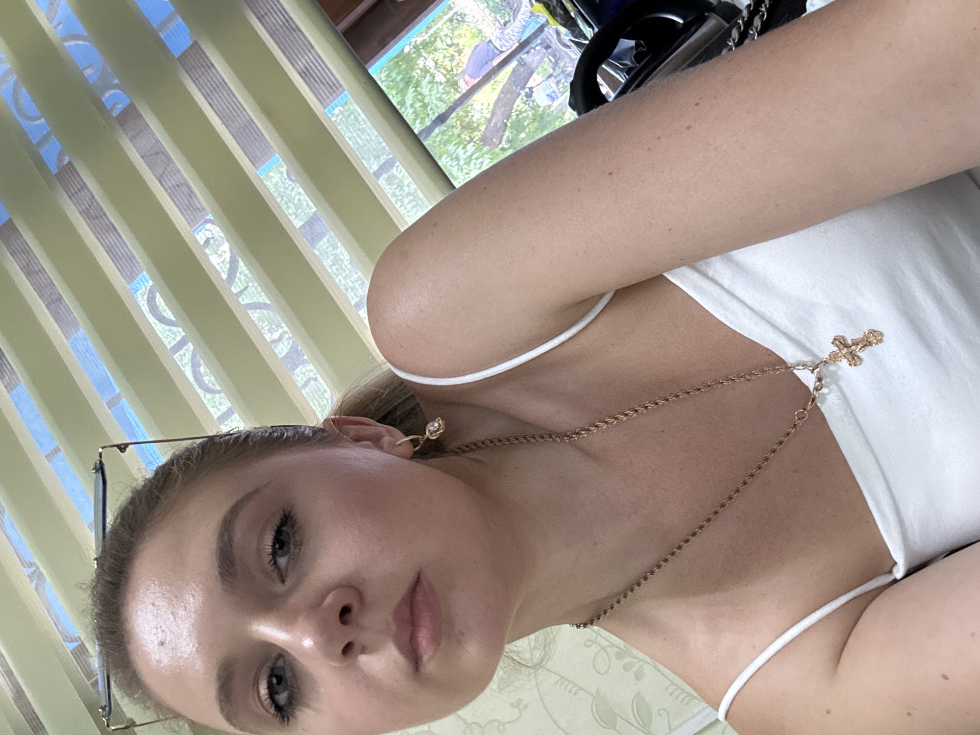 Indoor selfie session, white tank top and gold cross necklace