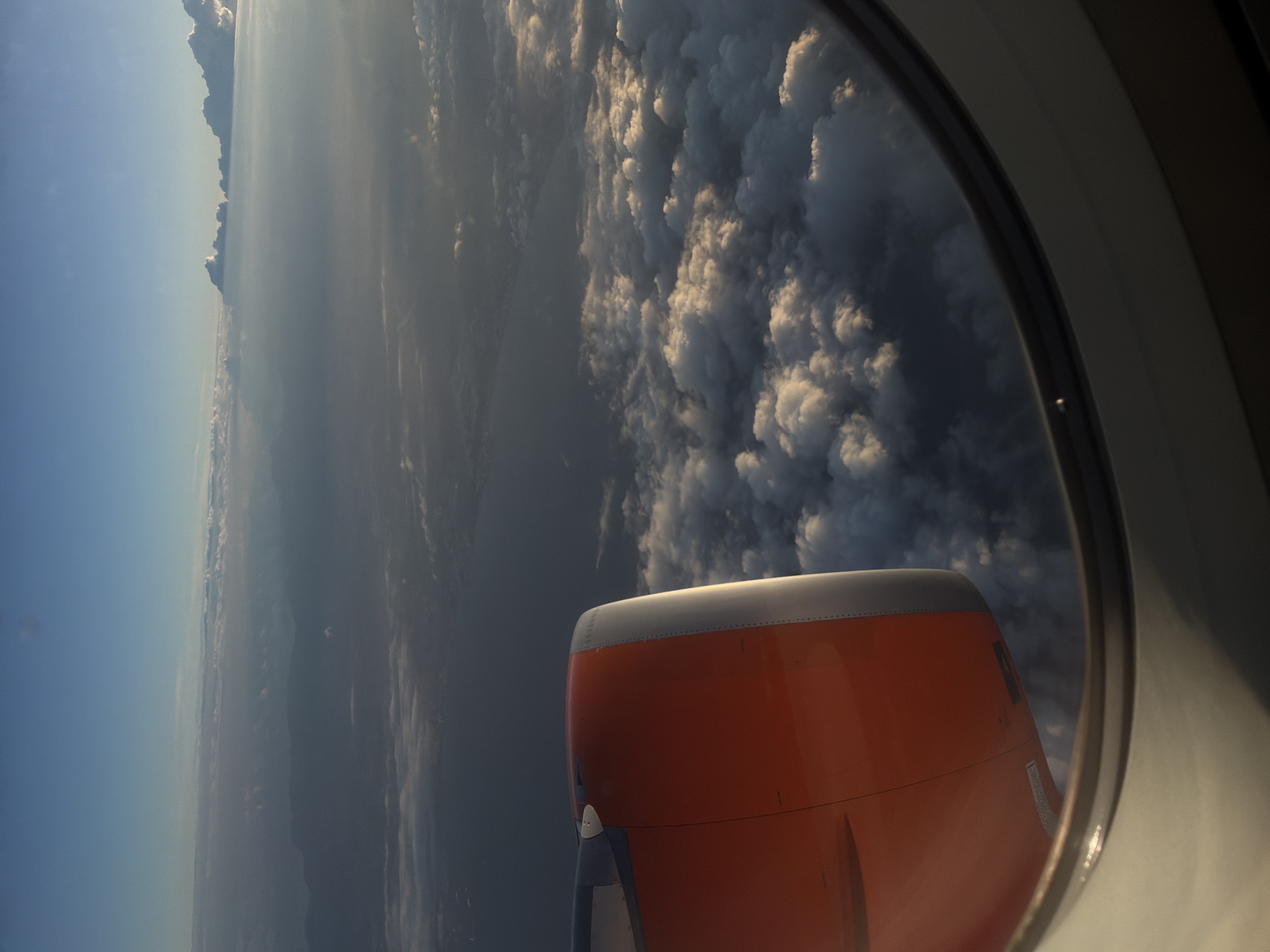 Airplane window view captured over Palma coastline