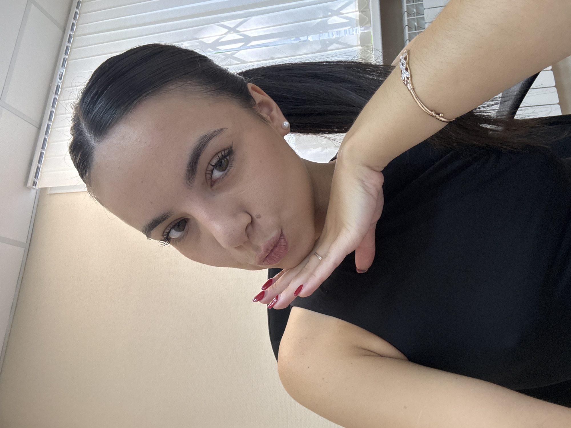 Casual selfie, black top and rose gold bracelet.