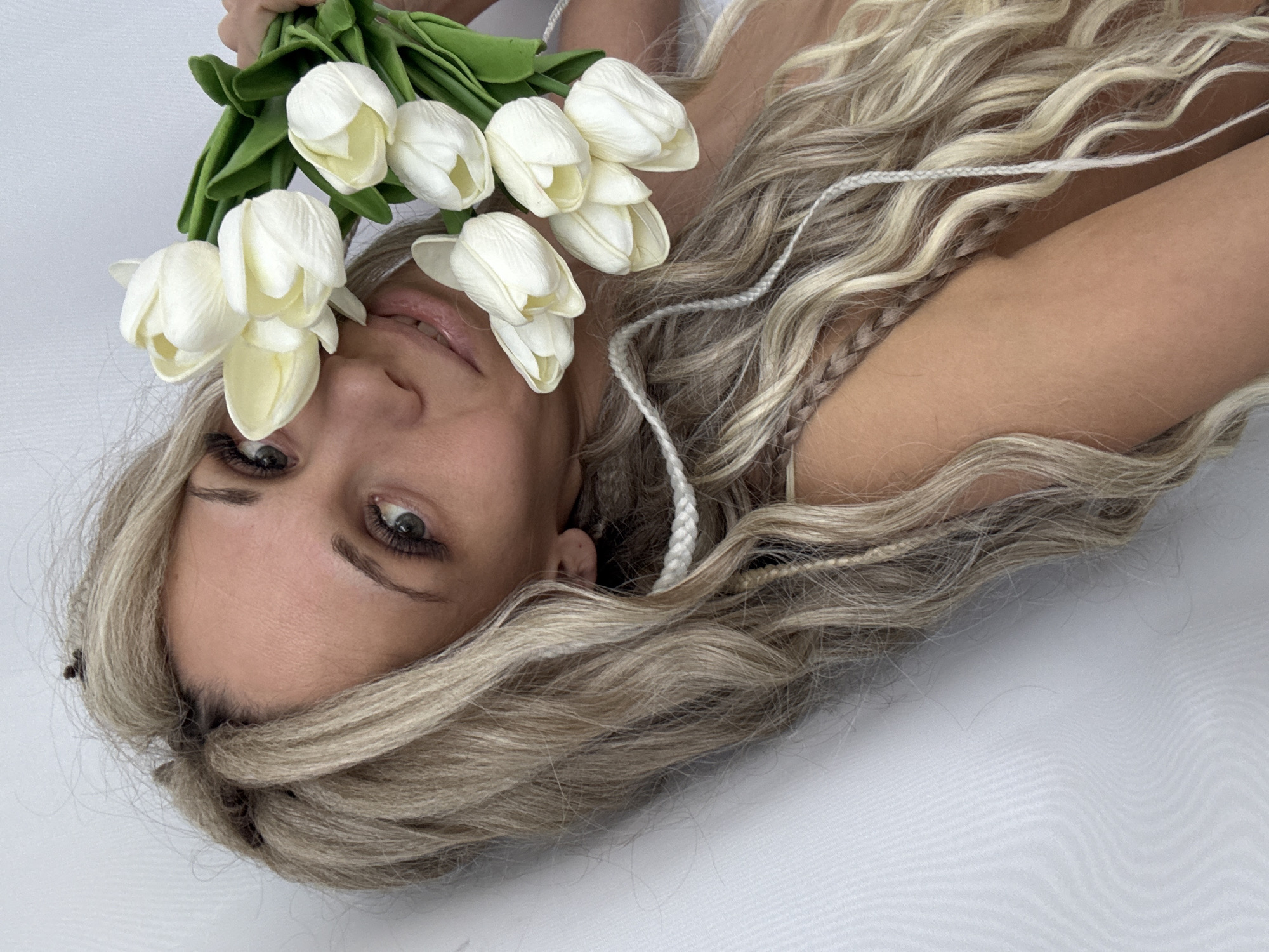 Woman photographed with white tulips in Rusanovo, Russia