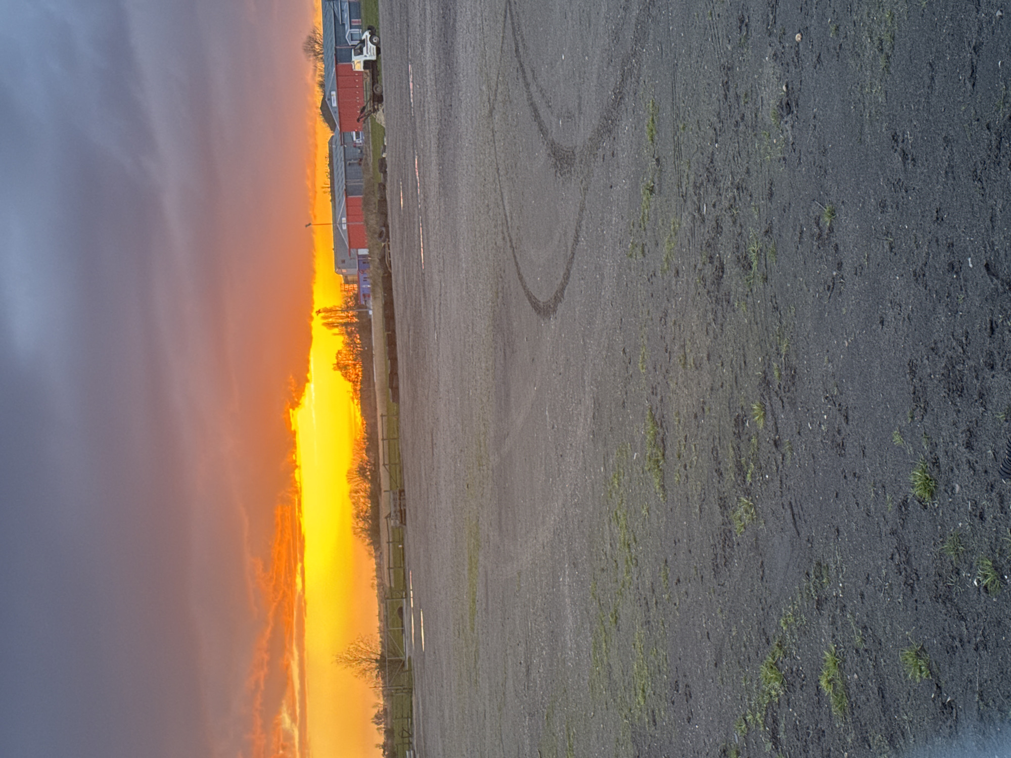 Sunset observed over wet roads in Caister-on-Sea