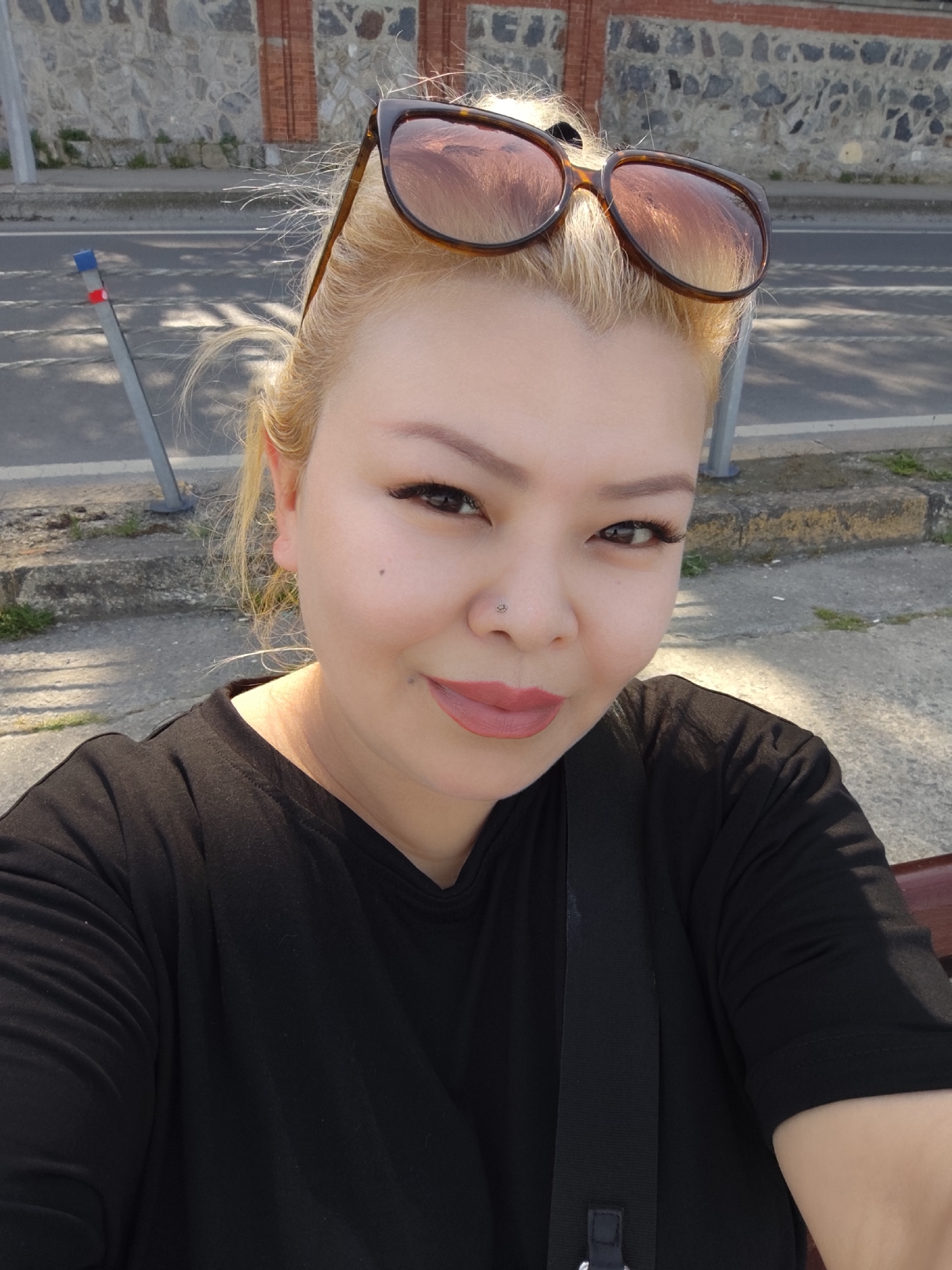 Woman photographs herself at Bosphorus waterfront in Sarıyer