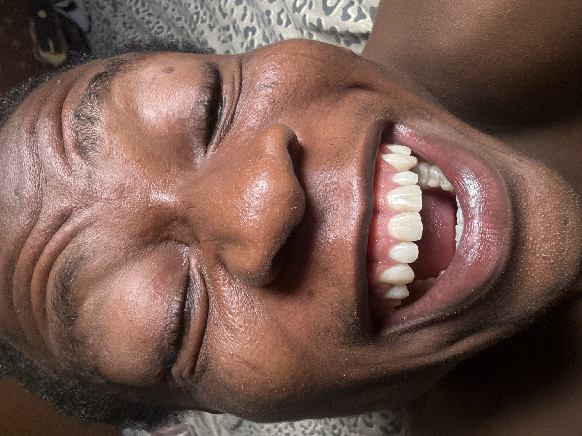 Person captured making animated expressions during private bedroom session