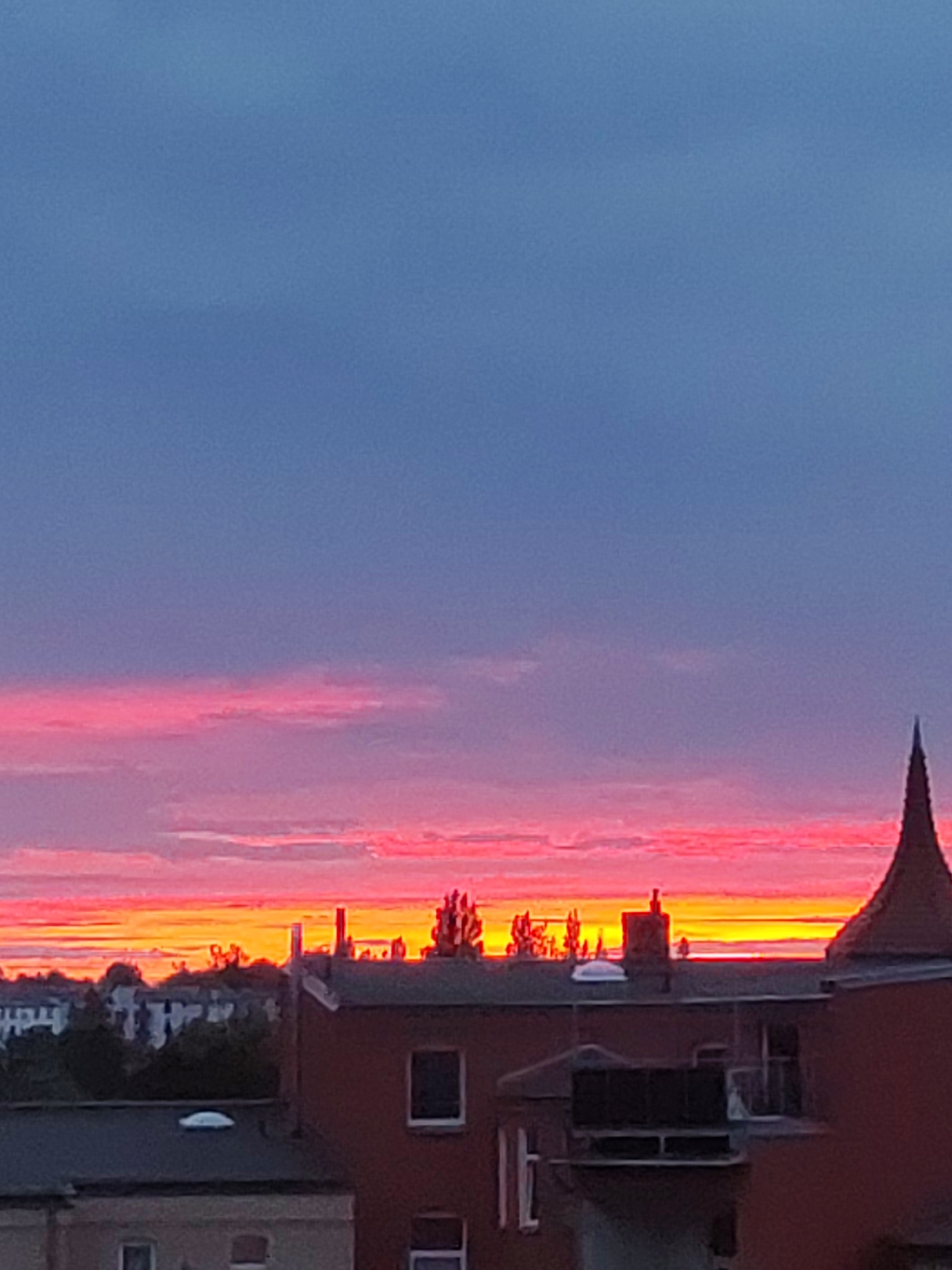 Schwerin skyline at dusk, city silhouetted against sunset colors.