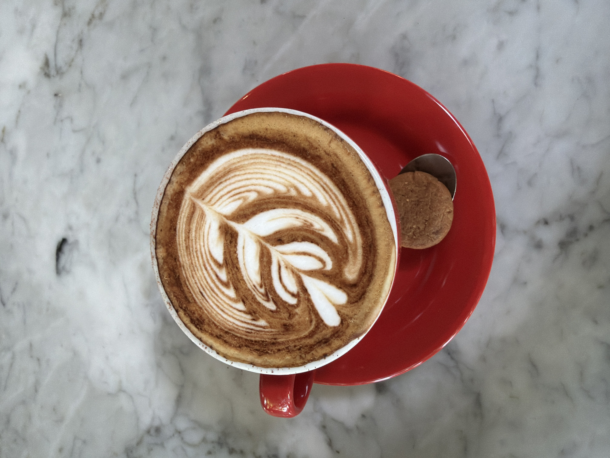 Cappuccino with latte art served in North Kuta