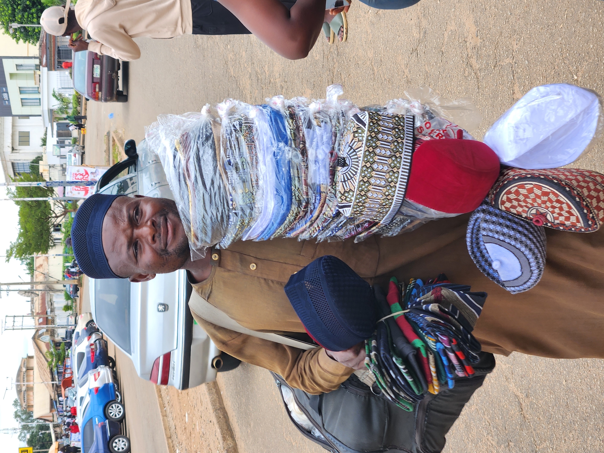 Midday street life and outdoor prayers in Jos, Nigeria