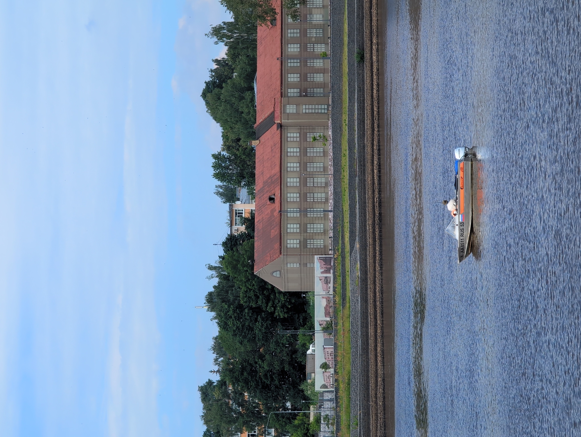 Summer morning activity along Veliky Novgorod's Volkhov River embankment