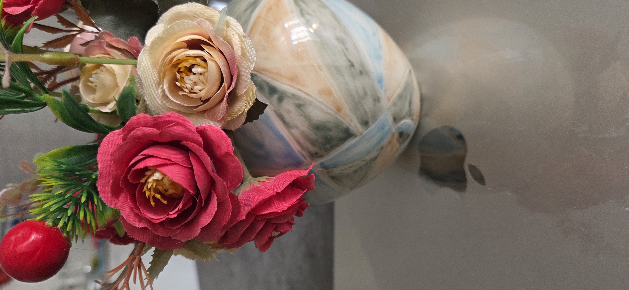 Artificial floral arrangement with ceramic object documented