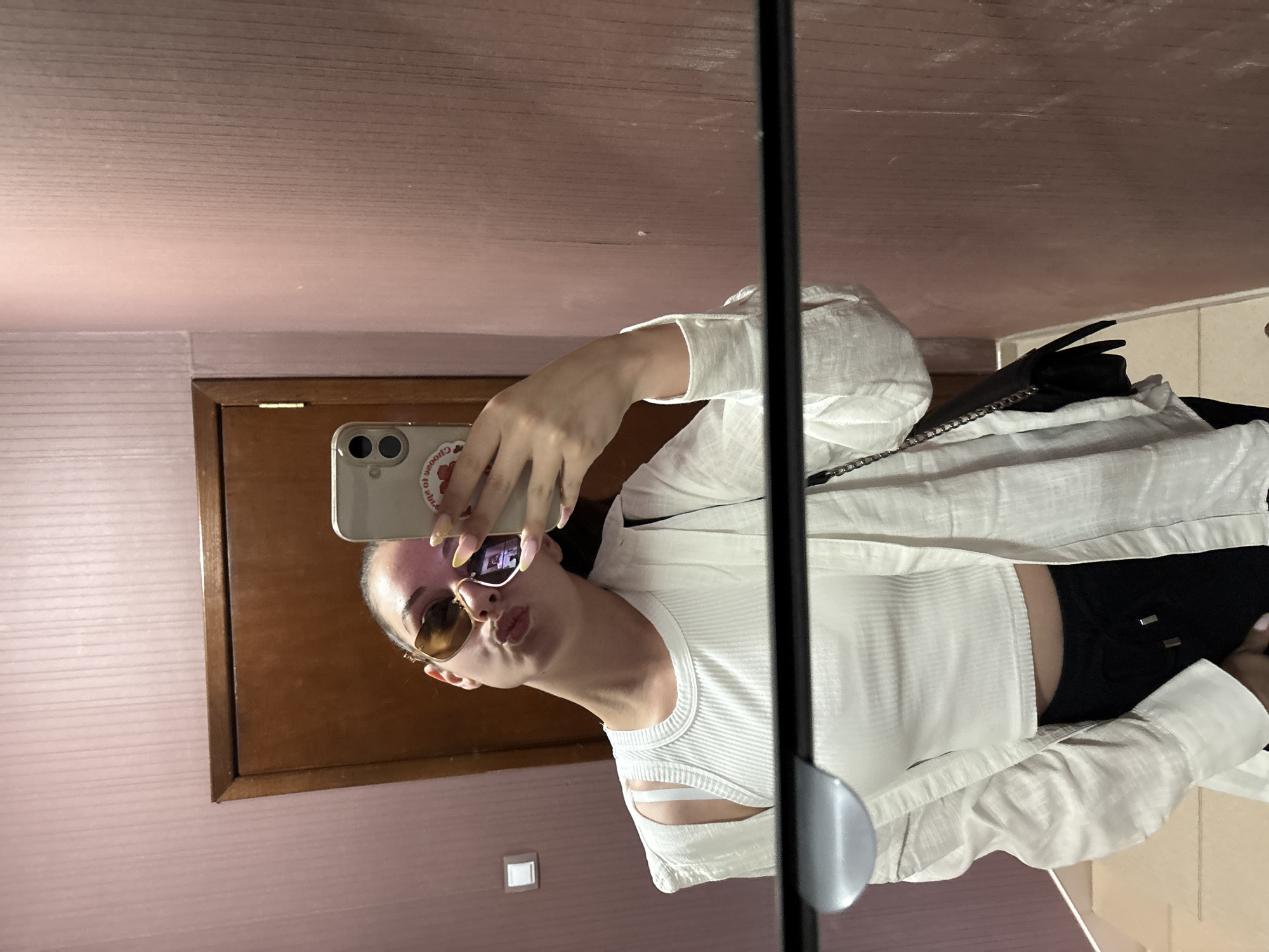 Woman takes mirror selfies in bedroom in Bulgarovo, Bulgaria