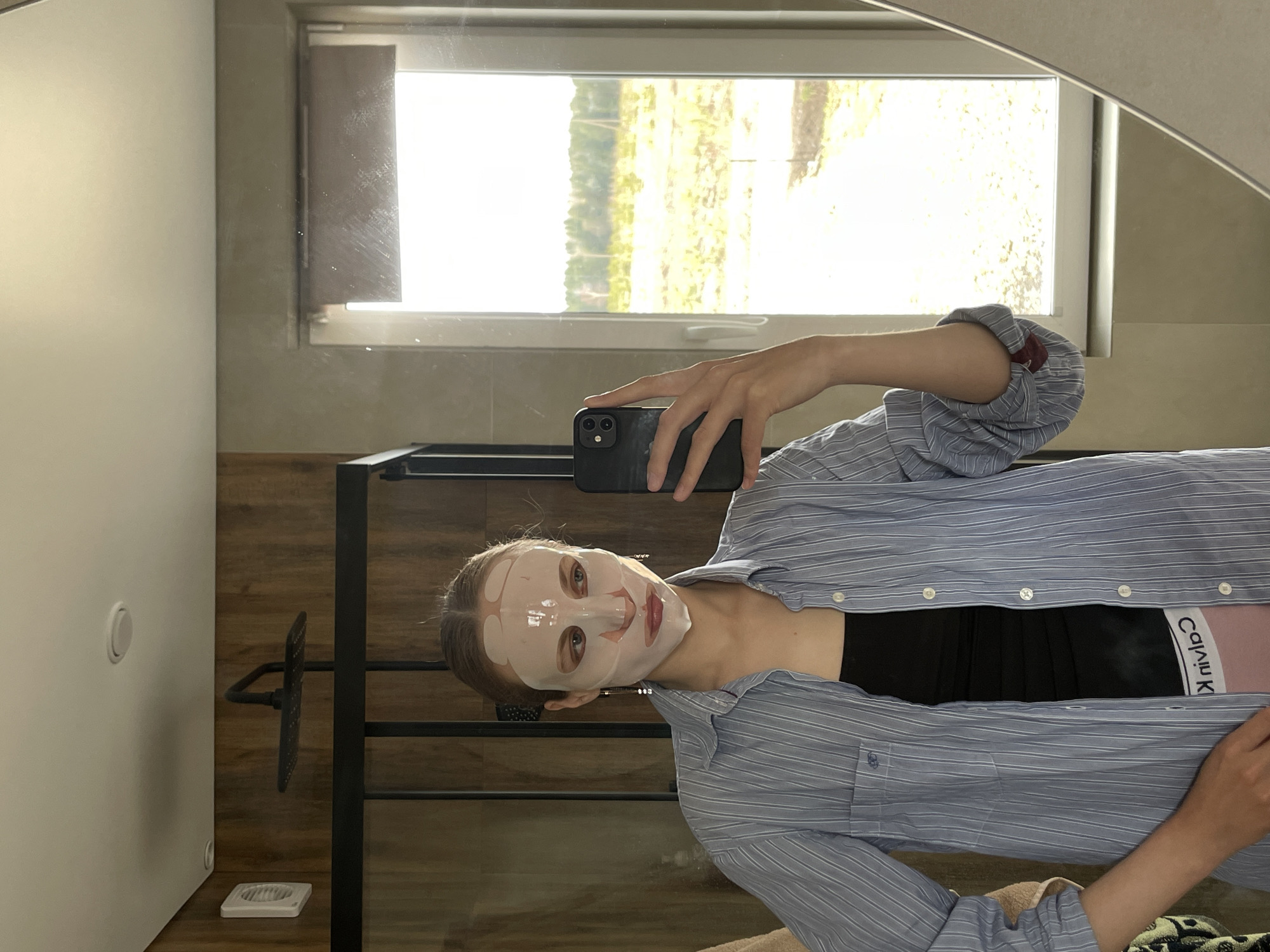 Woman documents skincare routine with face mask in Russian village