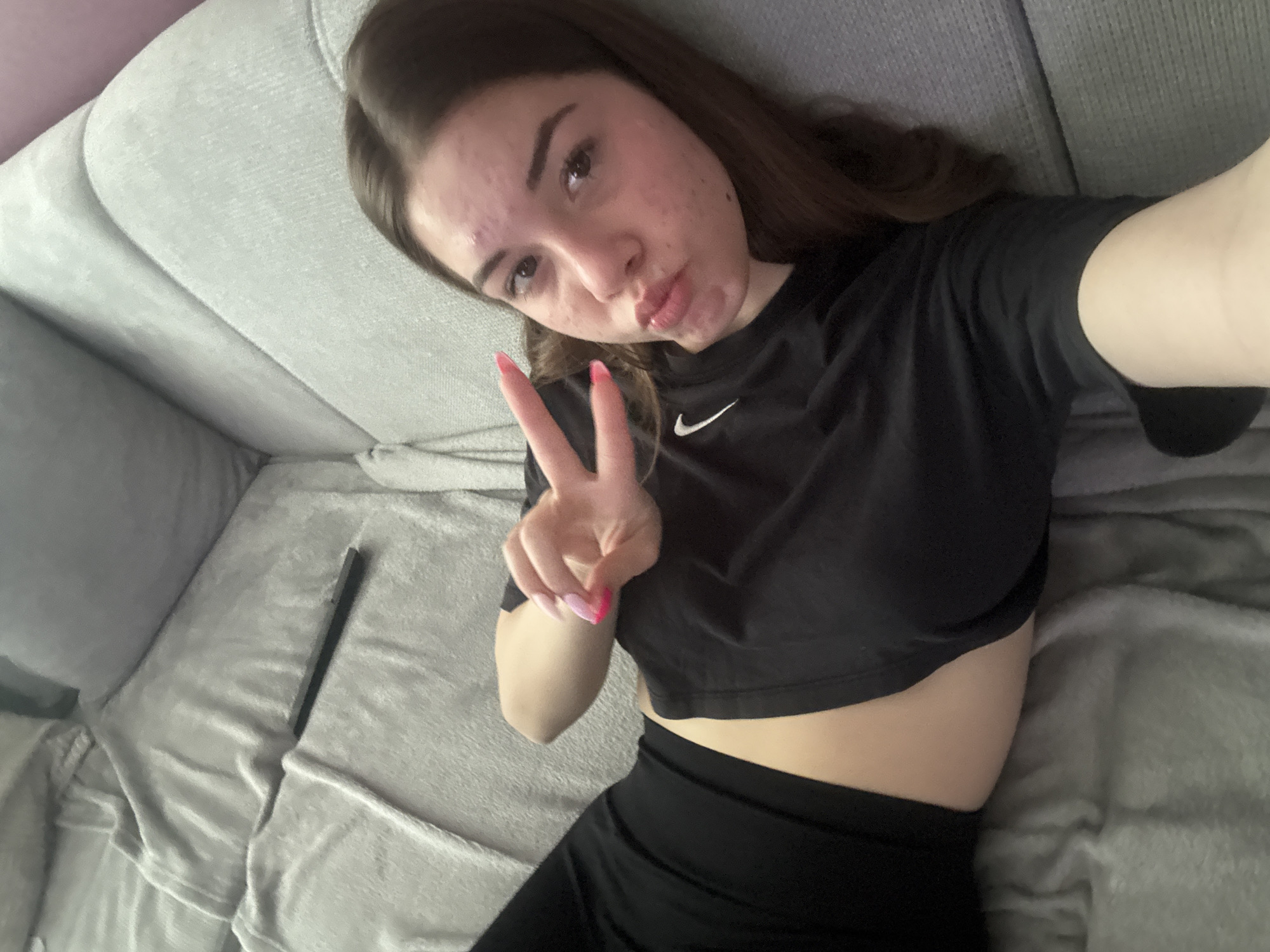 Woman takes selfie on grey sofa in Plovdiv