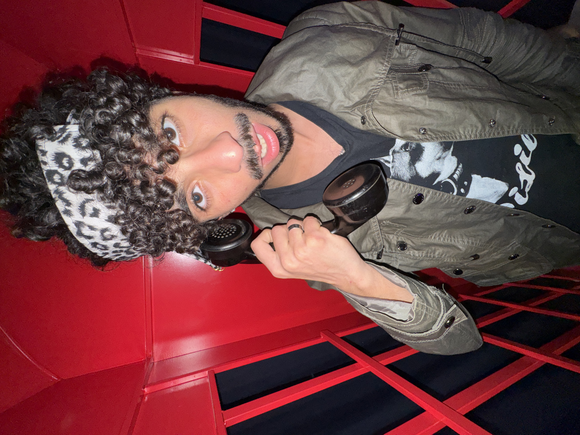 Man poses in decorated British phone booth in Créteil