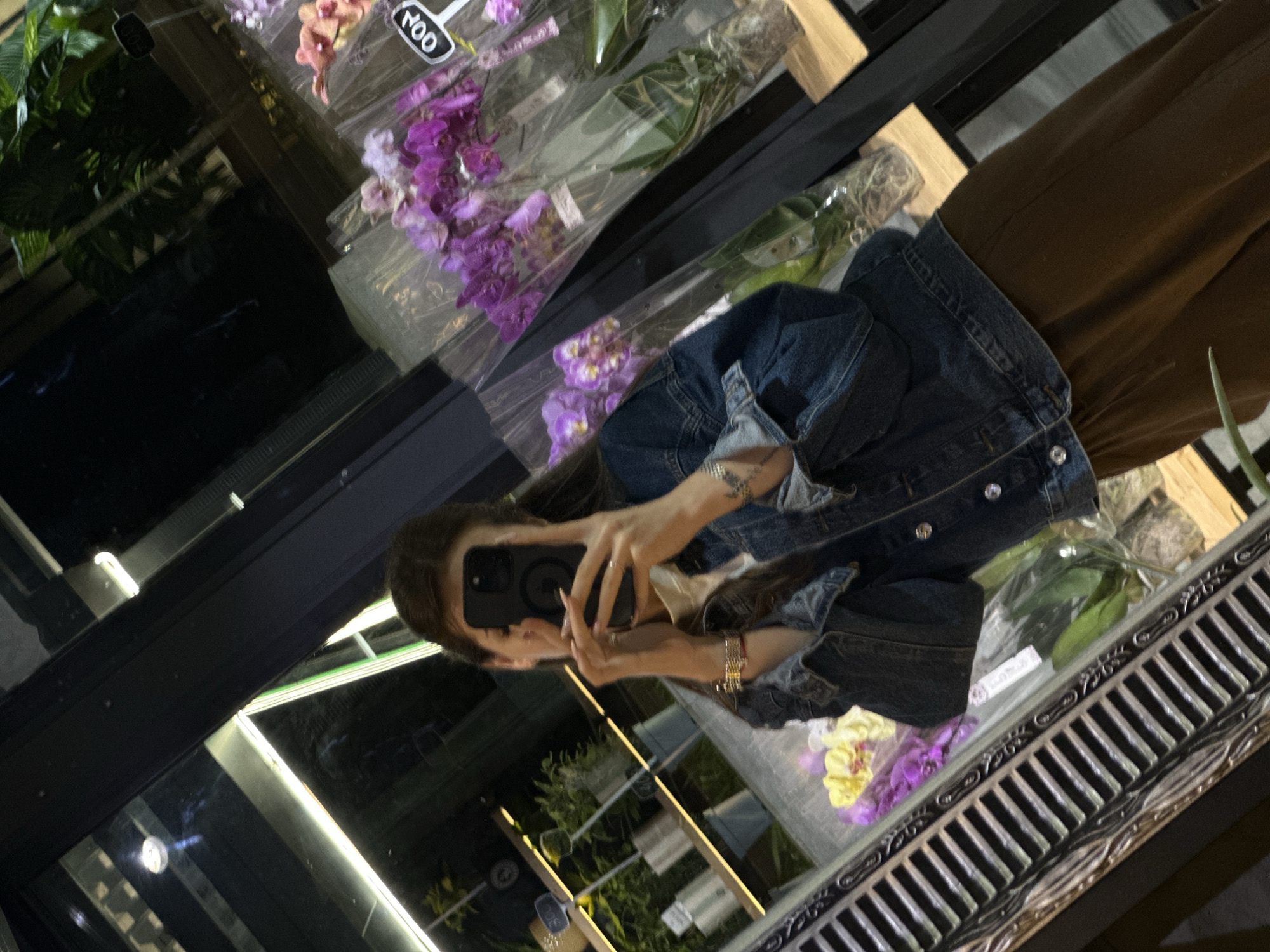 Woman documents evening flower shop visit in Chișinău