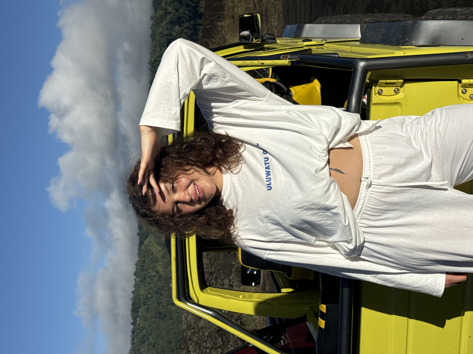 Woman poses with yellow jeep in Kintamani mountains