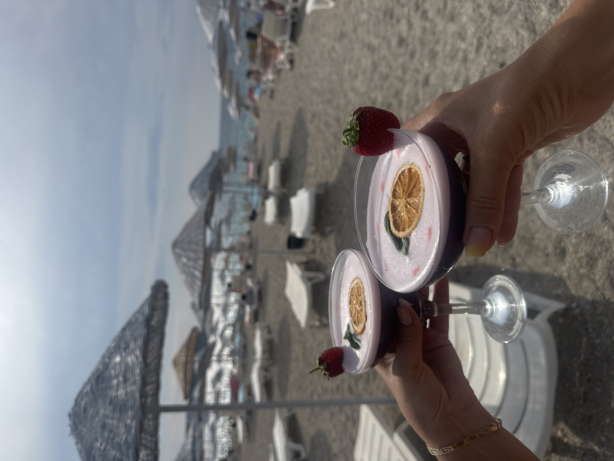 Fancy garnished cocktails raised outdoors in Foça