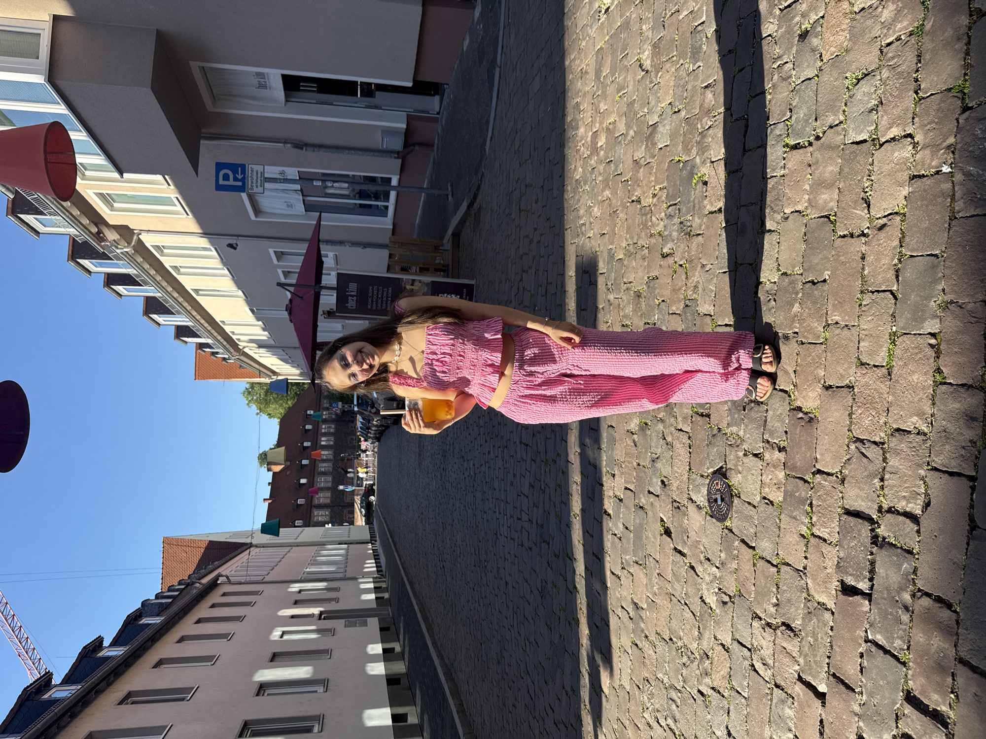 Young women enjoy beverages on Hanau street