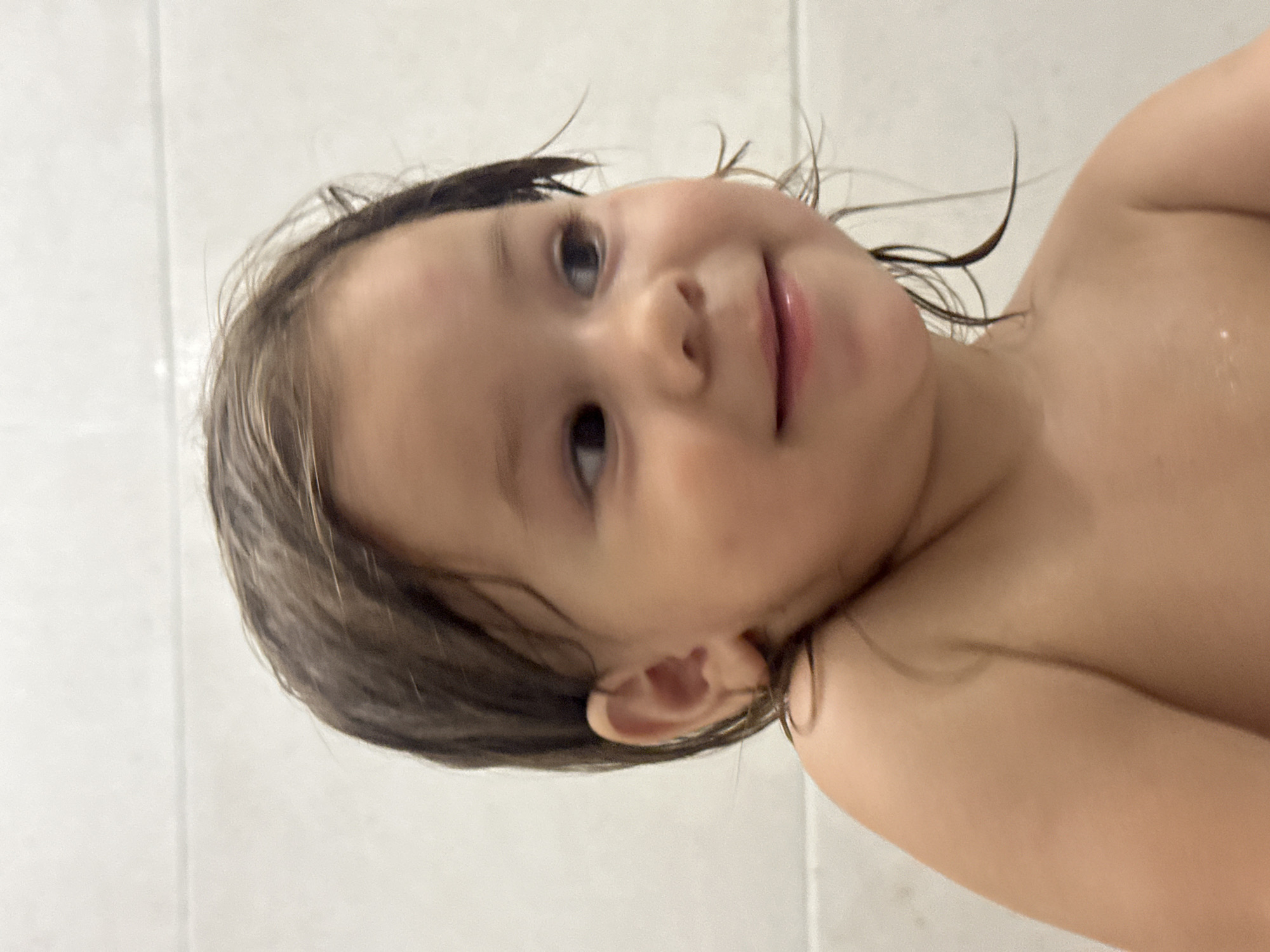 Post-bath toddler moments at home in Kharnavy, Russia