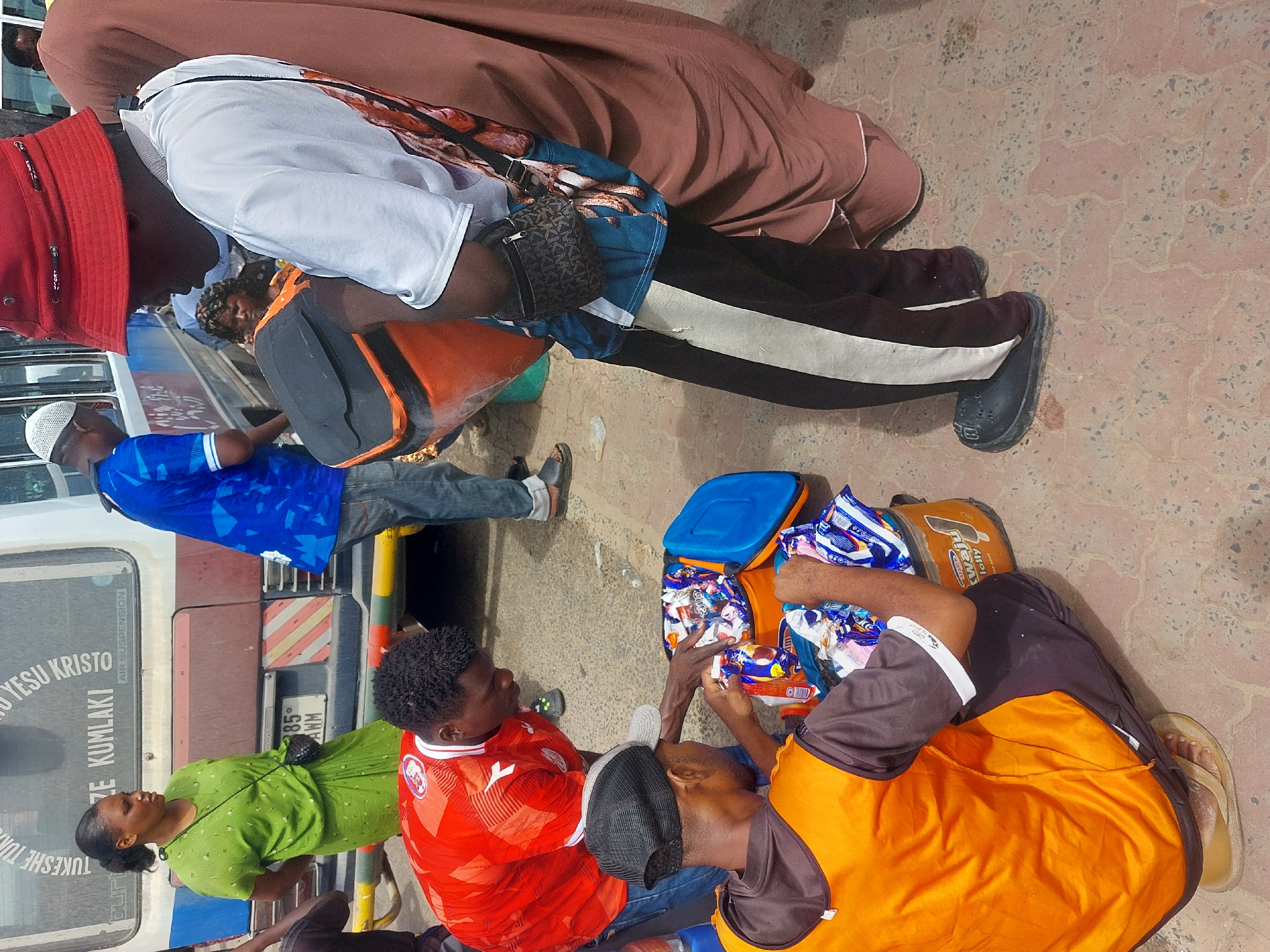 Street vendors serve customers at busy Dar es-Salaam transport hub