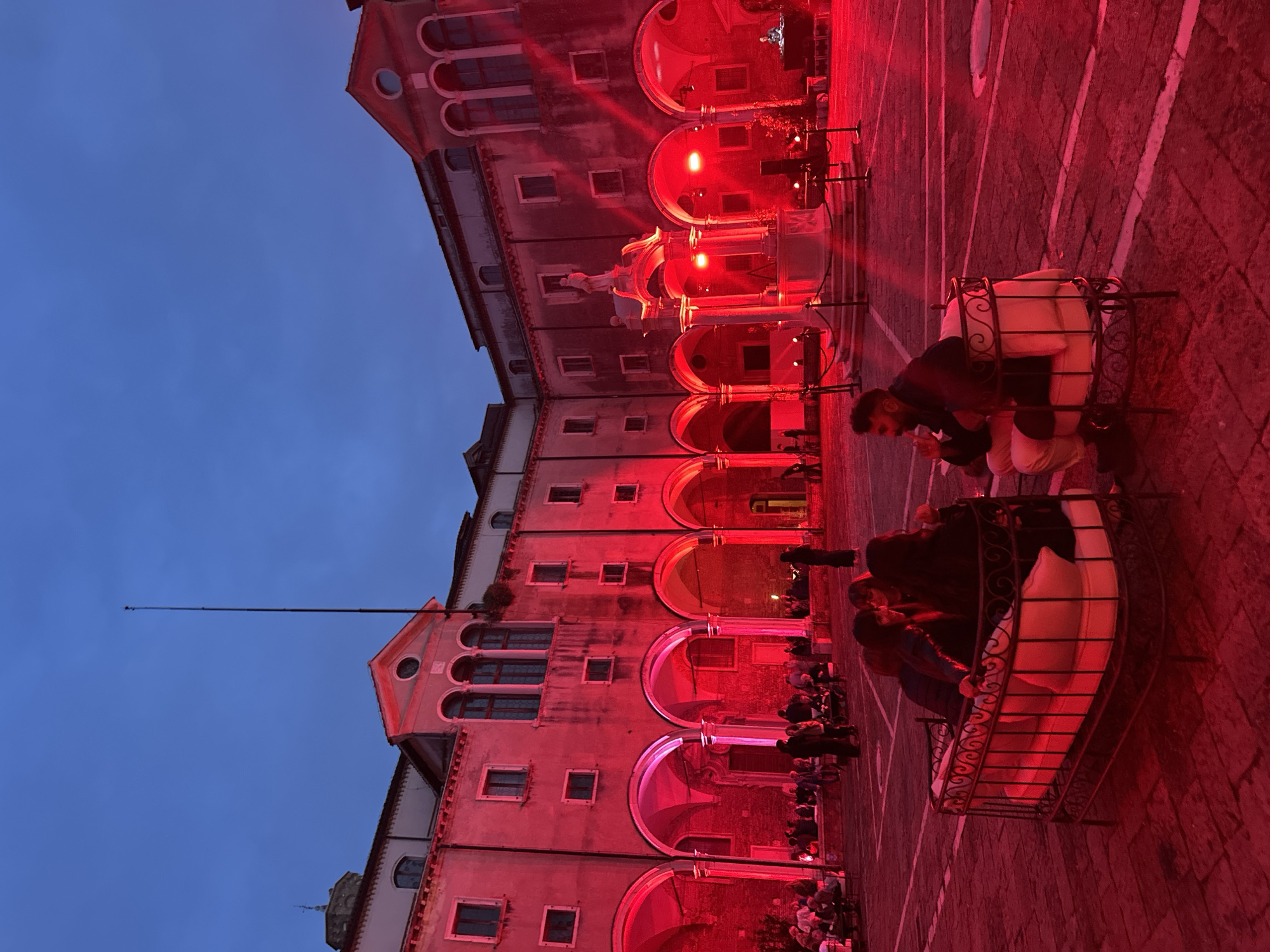 Red-lit building draws crowds to outdoor seating in Venice