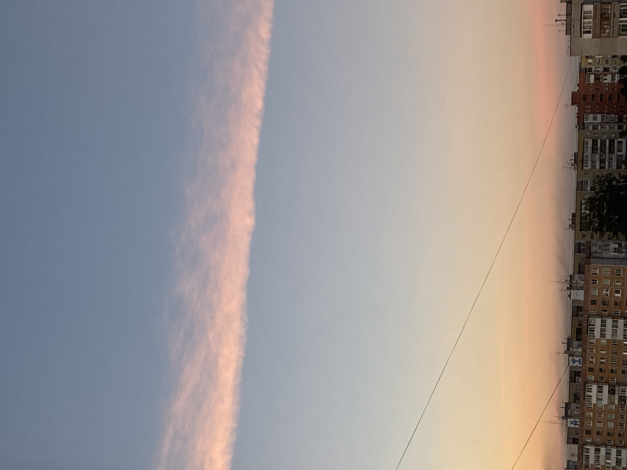 Sunset cityscape with distinctive streaking clouds documented across 16 minutes
