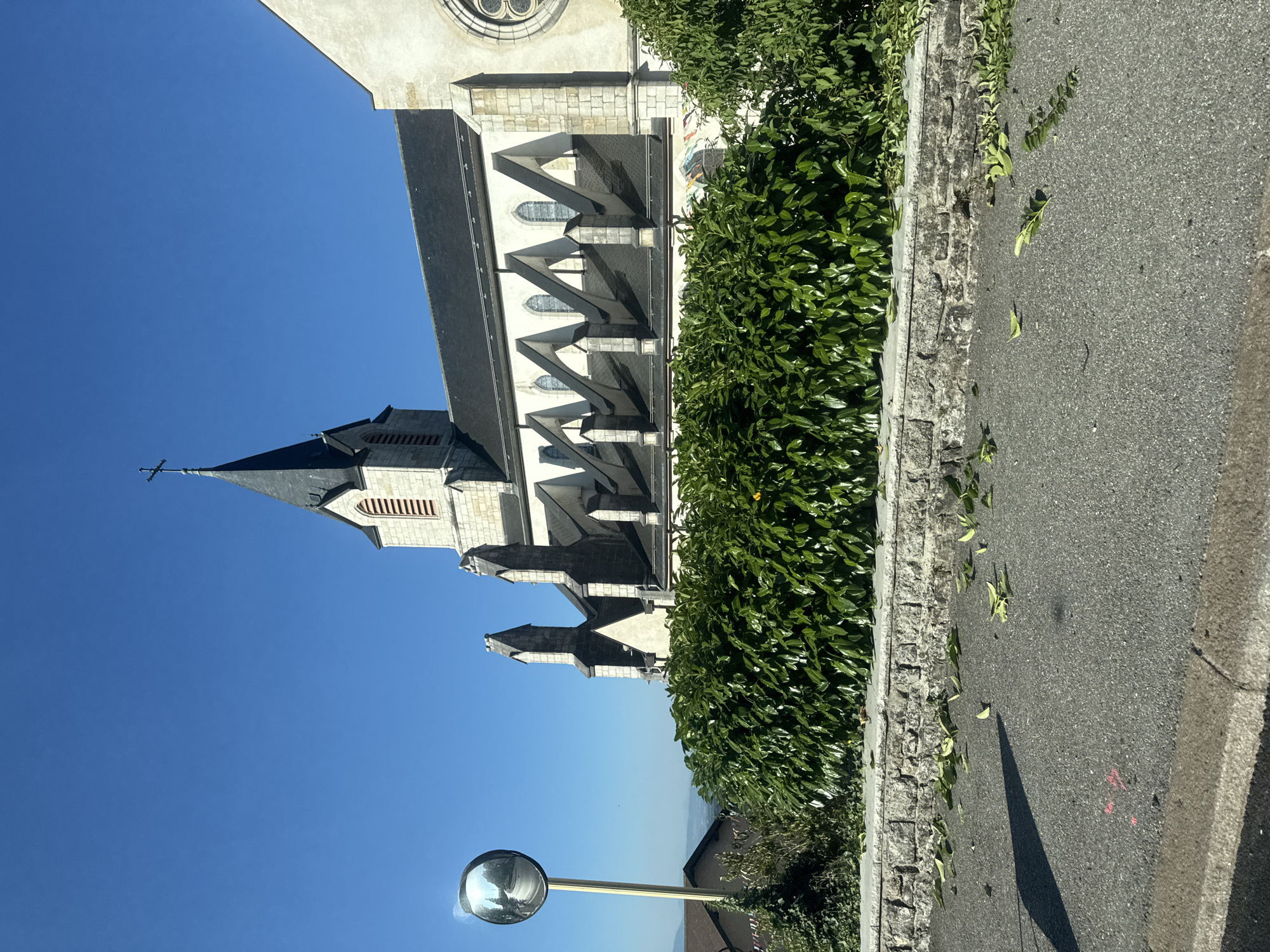 Church steeple and festive banners in central Gex, France