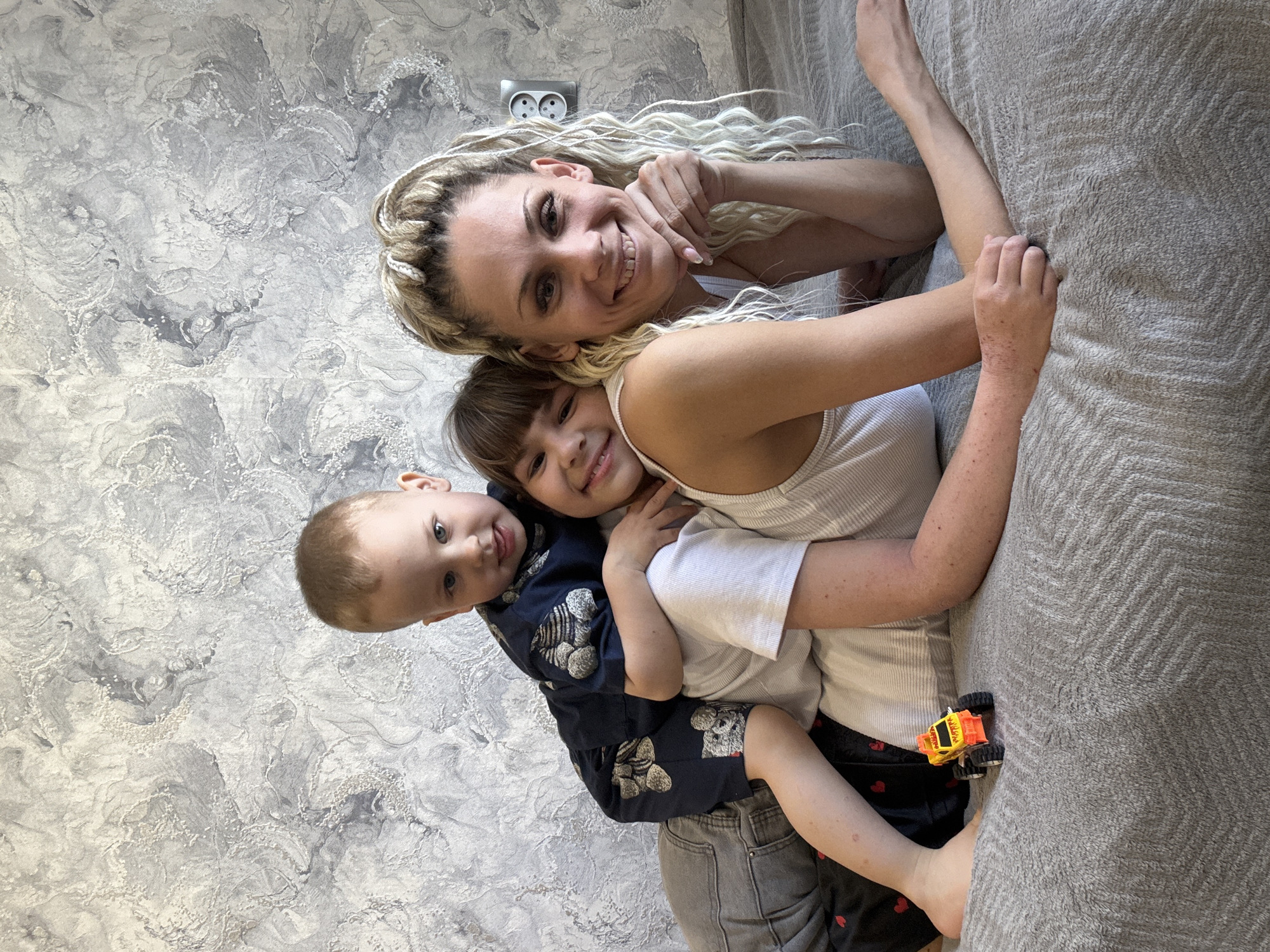 Mother and children share quiet moment in Zavolzhye home