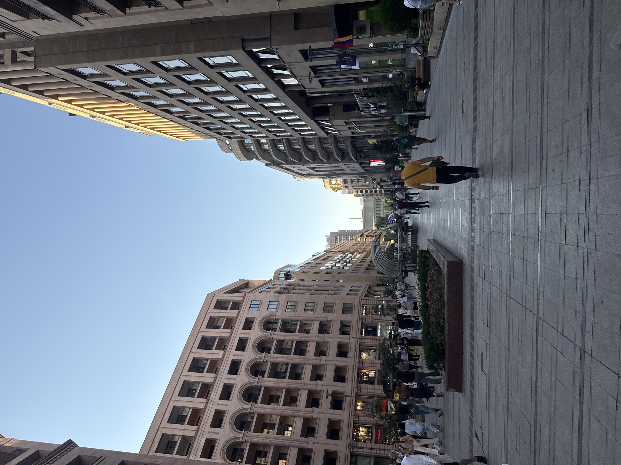 Street life, murals, and a busker in a busy urban district
